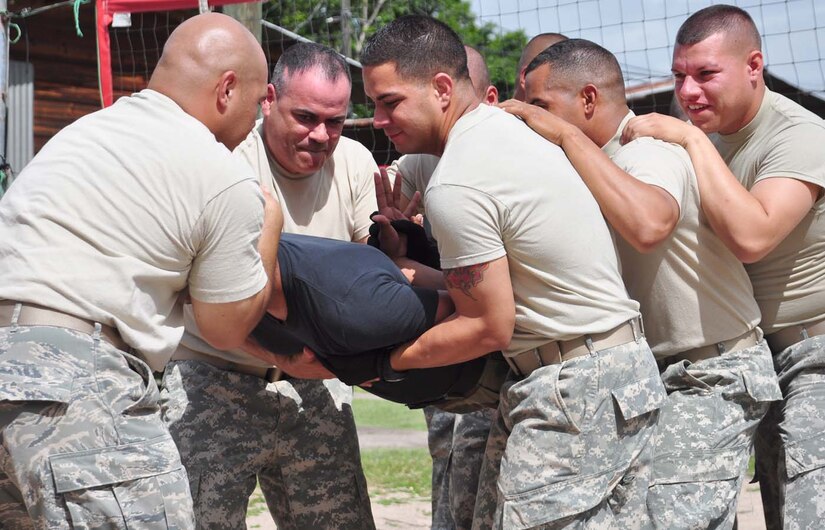SOTO CANO AIR BASE, Honduras — Joint Security Forces members practice removing a member from a crowd during the riot control portion of the nonlethal training here Aug. 20 at the JSF compound. The riot teams move as cohesive units to quickly act and remove hostile members when necessary (U.S. Air Force photo/Staff. Sgt. Chad Thompson).