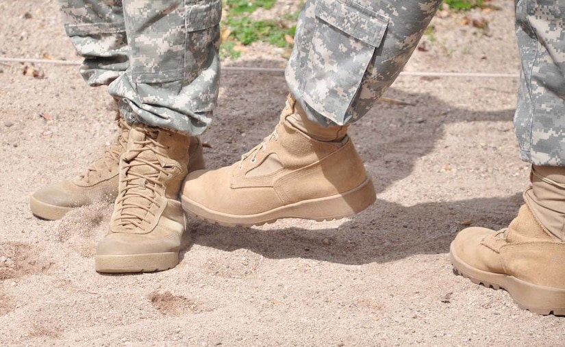 SOTO CANO AIR BASE, Honduras — Two Soldiers practice some ankle pressure point techniques during the pressure point control portion of the nonlethal training here Aug. 20 at the JSF compound. Pressure point control is a technique law enforcement members use to get subjects off balance and under control (U.S. Air Force photo/Staff. Sgt. Chad Thompson).