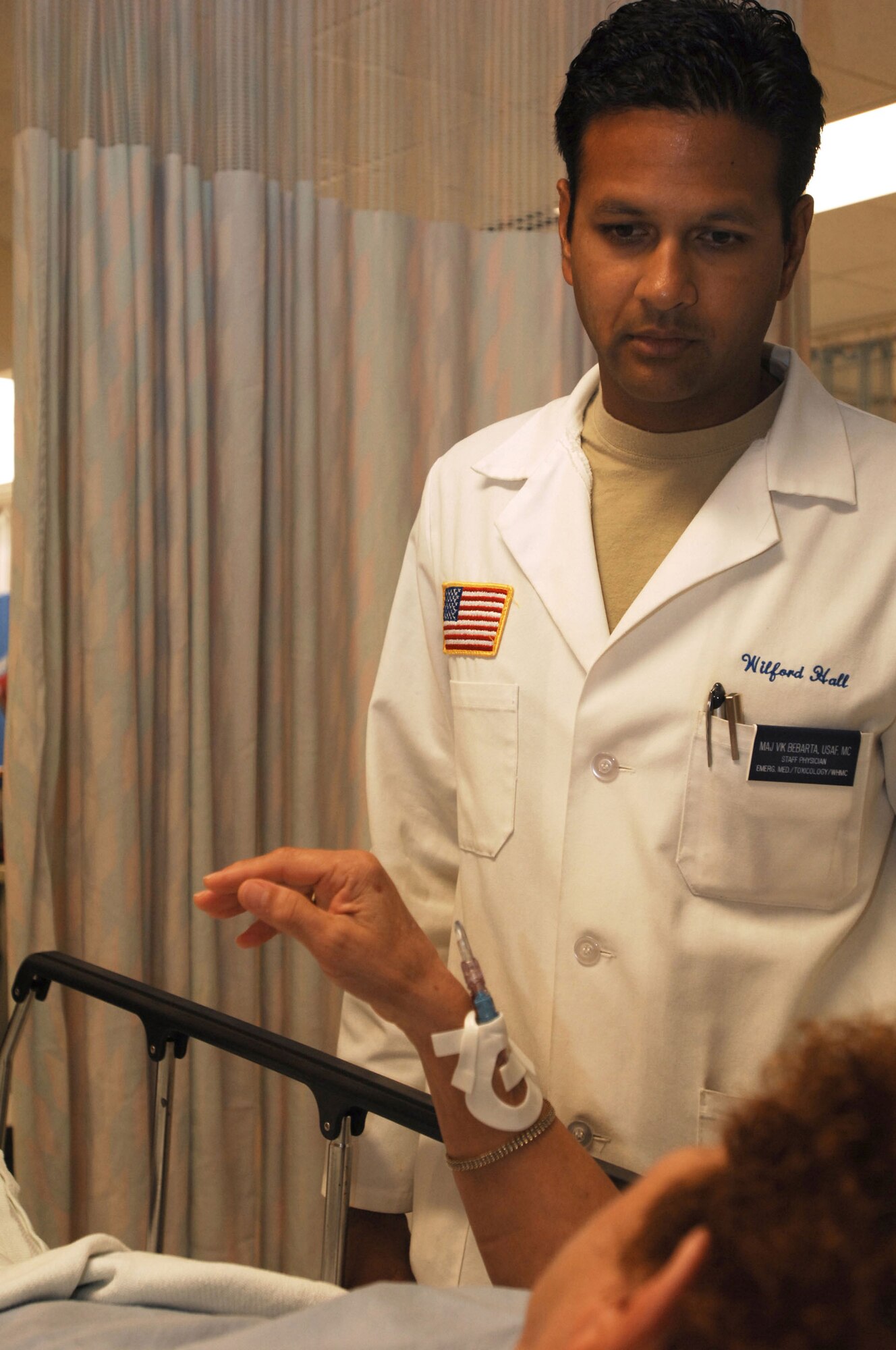 Maj. (Dr.) Vikhyat Bebarta, 59th Emergency Medicine Squadron, chief of medical toxicology, talks with a patient in the emergency room located at Wilford Hall Medical Center, Lackland Air Force Base, TX, Aug. 20, 2009. Dr. Bebarta will be presented the Donald F. Hagen Young Physician Award in November. (U.S. Air Force photo by Senior Airman Amber Bressler)