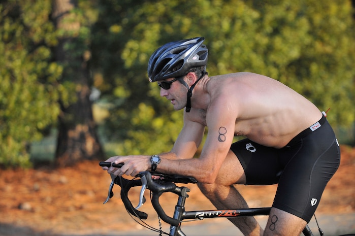 Matthew Jarrett reaches the finish of the 14,500-meter bicycling portion of a triathlon held here Aug. 22. The Fitness and Sports Center held the Charleston AFB Seventh Annual Swim-Bike-Run for Fun Sprint Triathlon to test participants? fitness and promote healthy activity. Jarrett is the chief of flight safety for the 437th Airlift Wing. (U.S. Air Force photo/James M. Bowman)