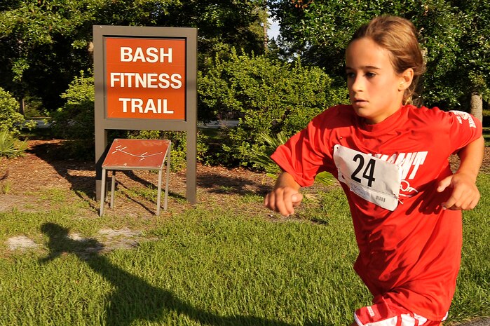 Carly Hall sprints to the finish line during the 5,000-meter running portion of a triathlon held here Aug. 22. Hall completed the 5K-run in 27 minutes, 36 seconds. Hall is the daughter of J.P. Hall, who was also a triathlon competitor. (U.S. Air Force photo/James M. Bowman)