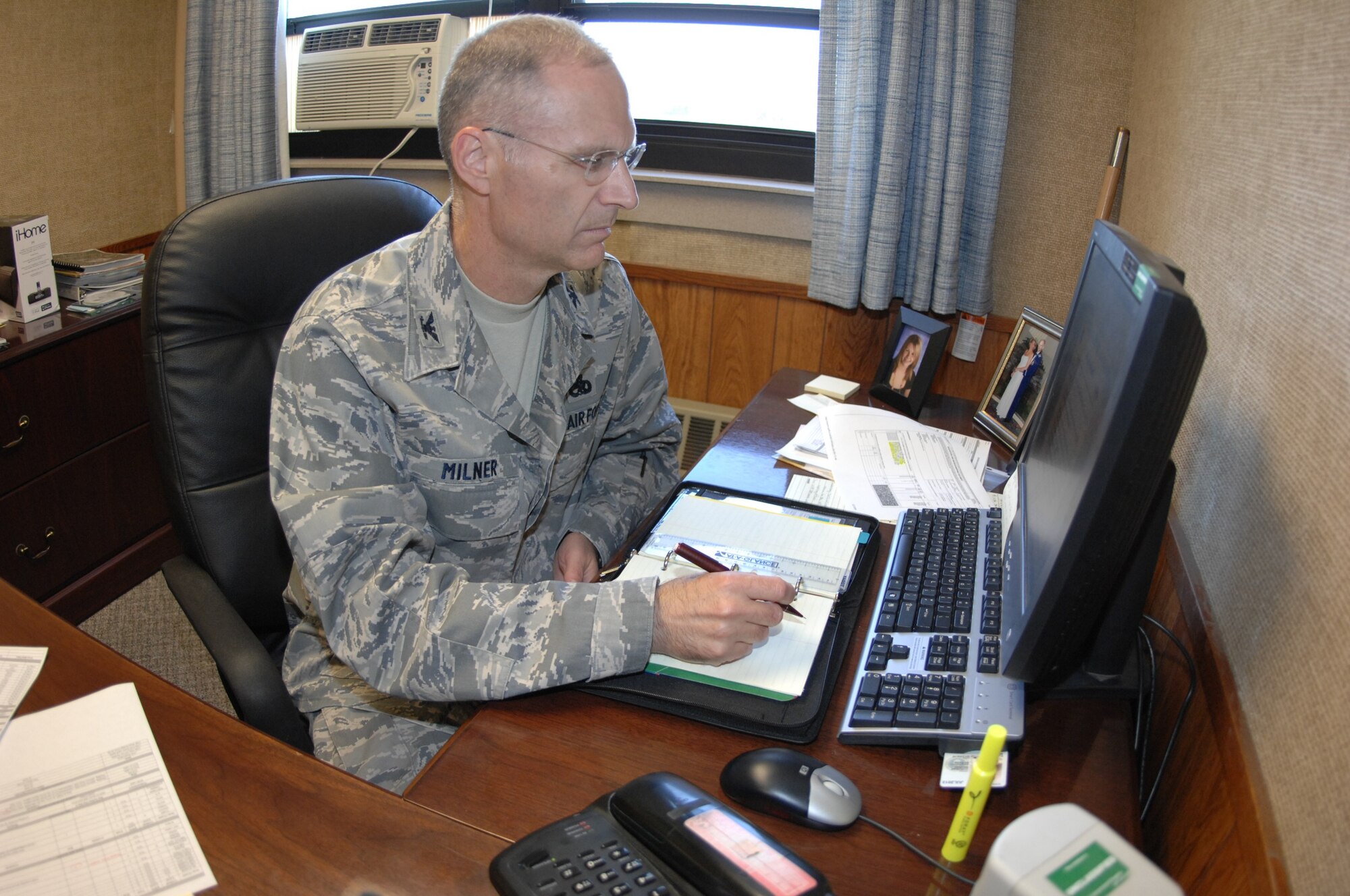 MINOT AIR FORCE BASE, N.D. -- Col. David Milner Jr., 798th Munitions Maintenance Group commander, listens in on a teleconference call in his office here Aug. 26. Colonel Milner recently assumed command of the 798th MUMG, which will consist of a command element and support staff of approximately 10 to 12 people performing administrative functions. The 798th MUMG is an important step toward establishing support for Air Force Global Strike Command and reinvigorating the nuclear enterprise in the Air Force. (U.S. Air Force photo by Senior Airman Wesley Wright)