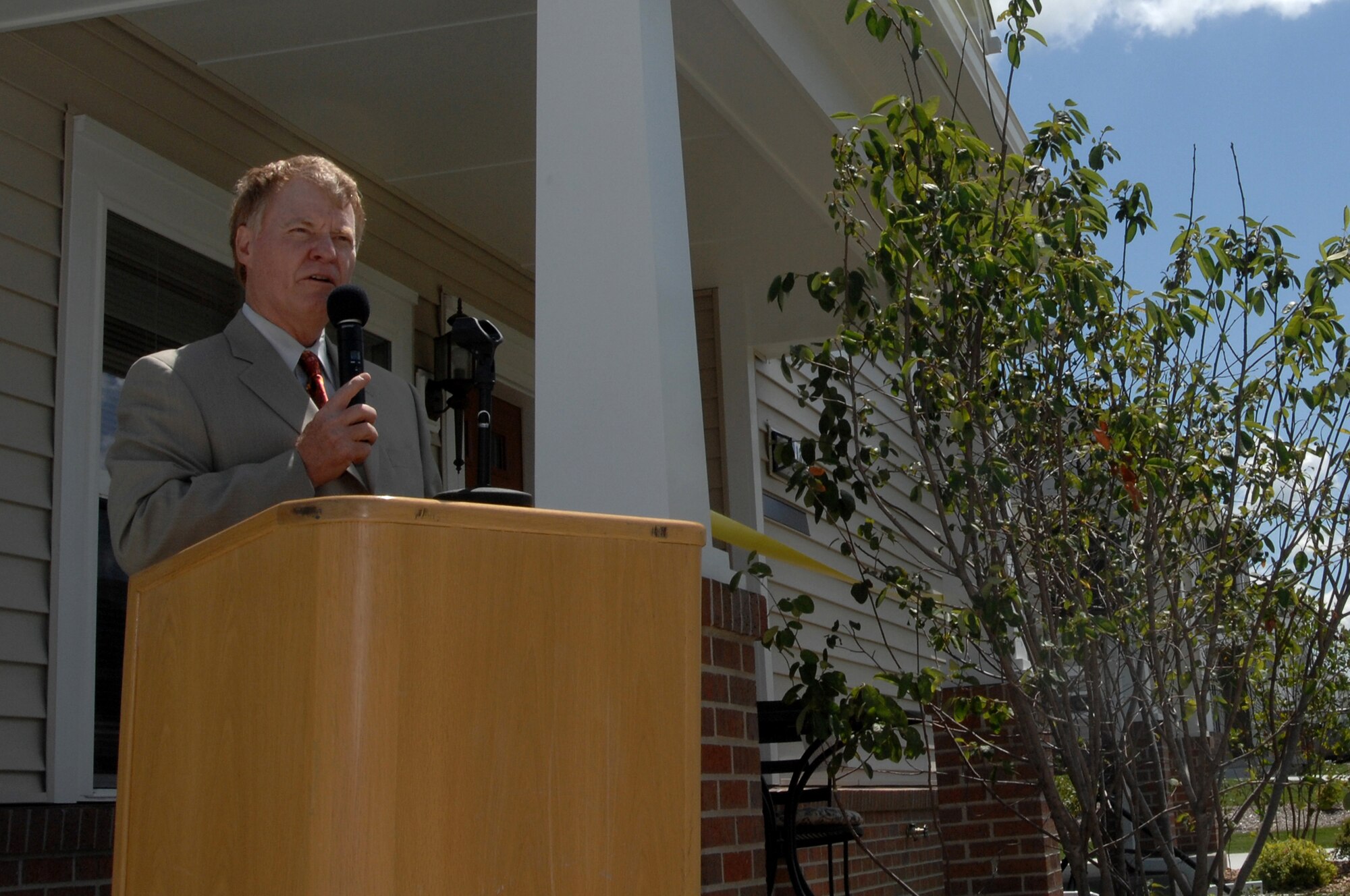WHITEMAN AIR FORCE BASE, Mo. - Dan Walsh, president of Walsh Construction, delivers a speech during a ribbon cutting ceremony Aug. 21 on Vosler Avenue. Walsh Construction is building new base houses in the Bear Lake subdivision here.  The family moving into this new home was Airman 1st Class Joseph Robin, 509th Bomb Wing Security Forces Squadron, his wife, Molly, and their 11-month old daughter, Charli. (U.S. Air Force photo/Senior Airman Kenny Holston)