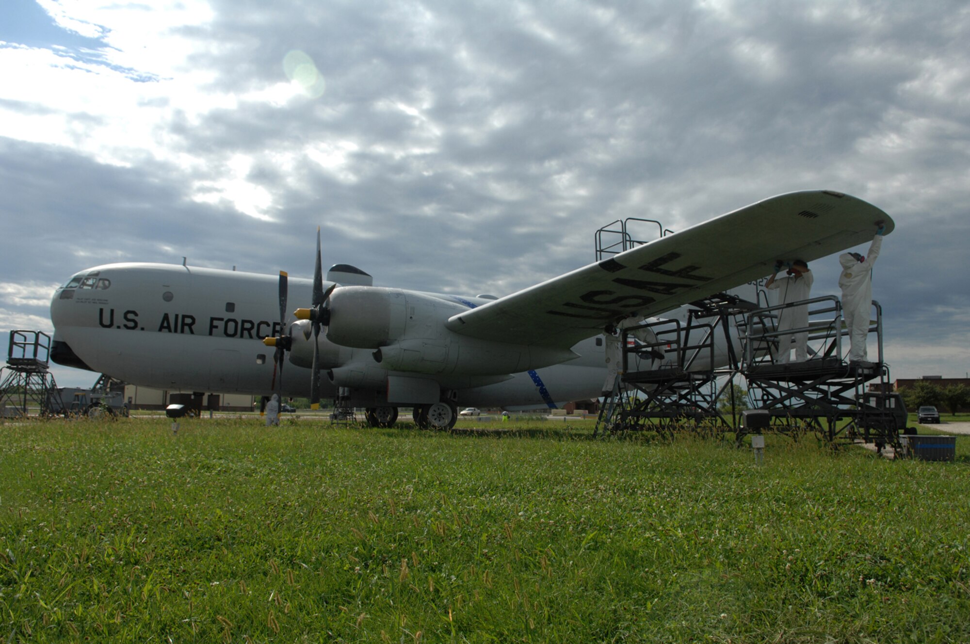 WHITEMAN AIR FORCE BASE, Mo. - Members from the 509th Maintenance and Munitions squadrons restore the protective coating on a KC-97 static display here Aug. 20. The restoration, which is required every five years, is scheduled to take a month. During this time Airman will sand, repaint and perform any required sheet metal repair to the KC-97. (U.S. Air Force photo/Senior Airman Jessica Snow)