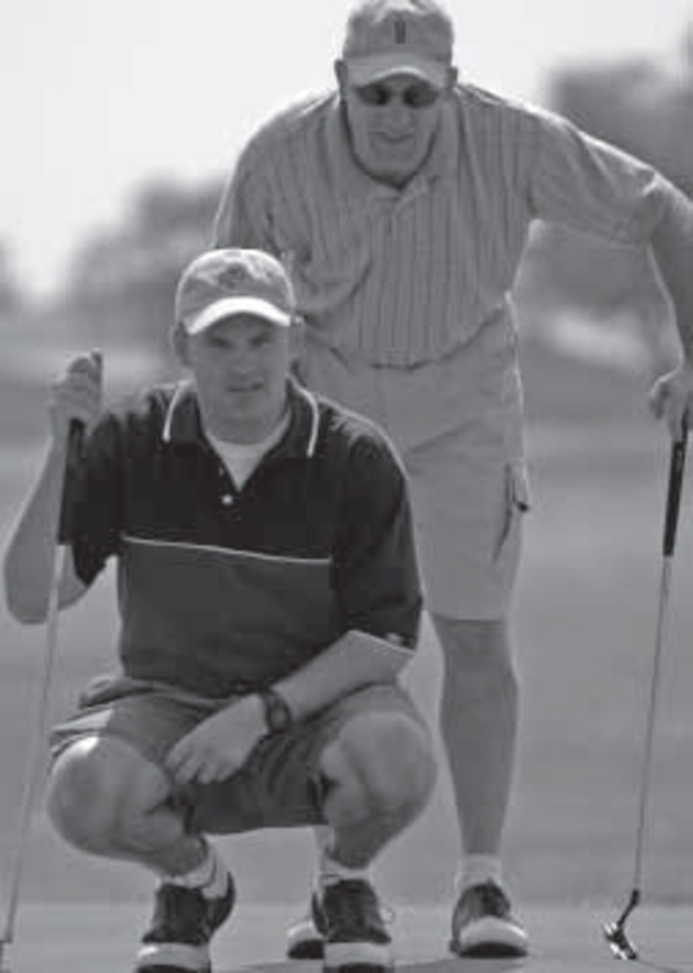 Tech. Sgt. Darren Horton and Capt. Brian Davis (on left) size up a putt while representing the 931st Air Refueling Group in an intramural championship golf match at McConnell Air Force Base, Kan., in 2004. After winning the 2004 and 2008 championship, the 931st team is scheduled to defend its title on Aug. 28. (U.S. Air Force photo/Tech. Sgt. Jason Schaap) 