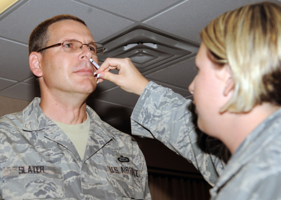 LANGLEY AIR FORCE BASE, Va. -- Chief Master Sgt. Kevin Slater, 1st Fighter Wing command chief, gets his intranasal influenza mist here Aug. 26. Everyone is required to have their flu mist and/or shot and are urged to have them done as soon as possible. (U.S. Air Force photo/Airman 1st Class Jonathan Koob)