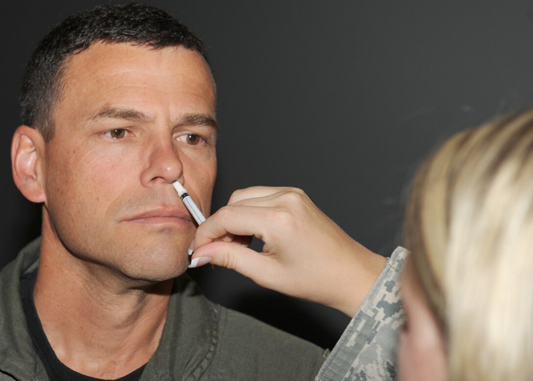 LANGLEY AIR FORCE BASE, Va. -- Col. Matt Molloy, 1st Fighter Wing commander, gets his intranasal influenza mist here Aug. 26. Everyone is required to have their flu mist and/or shot and are urged to have them done as soon as possible. (U.S. Air Force photo/Airman 1st Class Jonathan Koob)