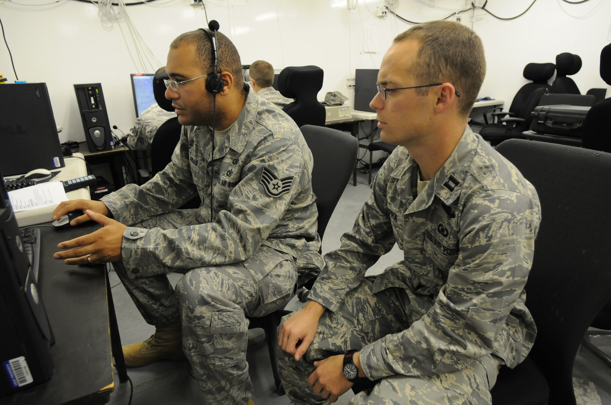 Tech. Sgt. Johnny Arias and Capt. James Capra, both from the 603rd Air Control Squadron, run a command and control simulation program to keep the unit mission-ready for deployments. The 603rd ACS is a mobile unit capable of providing radar control and surveillance within a designated area, to collect, display, and disseminate information of aerial activity and to provide radar coverage for the control of air forces. (U.S. Air Force photo/ Staff Sgt. Patrick Dixon)