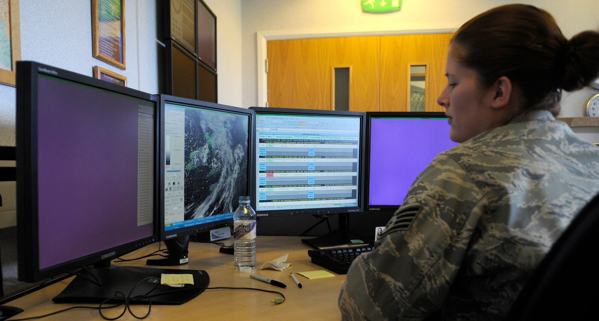 RAF MILDENHALL, England -- Staff Sgt. Ashley Jackson, 100th Operations Support Squadron weather flight, monitors several different programs and satellites as part of her duties as a weather systems technician Aug. 20.  (U.S. Air Force photo by Staff Sgt. Christopher L. Ingersoll)