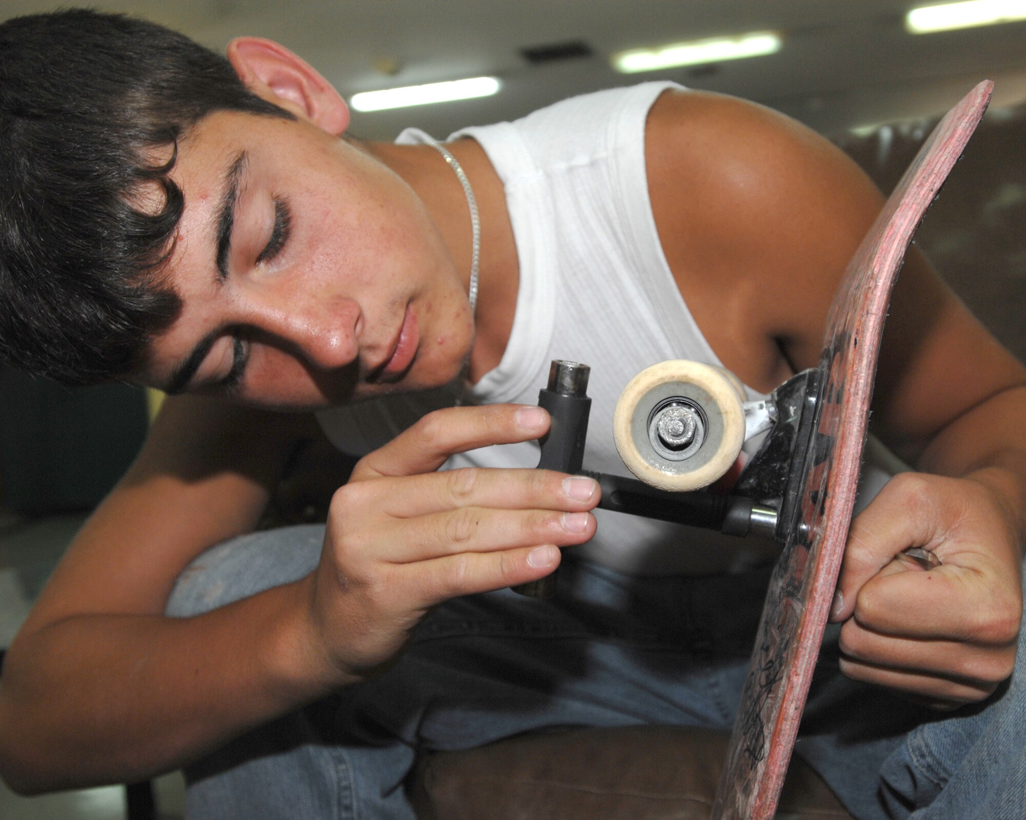 Matt Dalton installs new wheel trucks to his skateboard during a five-day skateboard camp at Incirlik Air Base Turkey, Friday, Aug. 21, 2009. Pro-skateboarders Falco Baltys and Doug Des Autels taught participants skateboarding fundamentals as well as safety and advanced tricks. Mr. Baltys and Mr. Des Autels work for the Premise 3-2-1 company which has been conducting skateboard camps around the military for many years. (U.S. Air Force photo/Staff Sgt. Lauren Padden)
