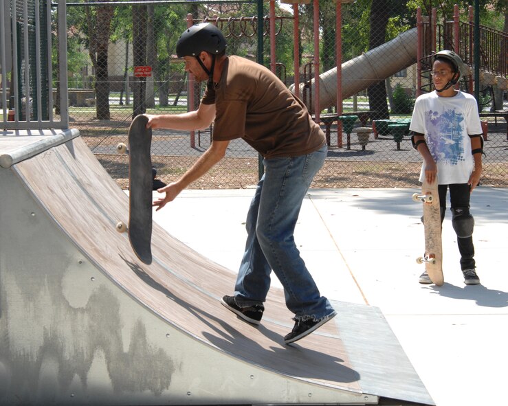 Professional skateboarder Falco Baltys demonstrates the proper technique to Chris Morillo, son of Tech. Sgt. Carlos Morillo, 728th Air Mobility Squadron, during the five-day skateboard camp at Incirlik Air Base, Turkey, Wednesday, Aug. 19, 2009. Pro-skateboarders Falco Baltys and Doug Des Autels taught participants the fundamentals of skateboarding as well as safety and advanced tricks. Mr. Baltys and Mr. Des Autels work for the Premise 3-2-1 company which has been conducting skateboard camps around the military for many years. (U.S. Air Force photo/Staff Sgt. Lauren Padden)

