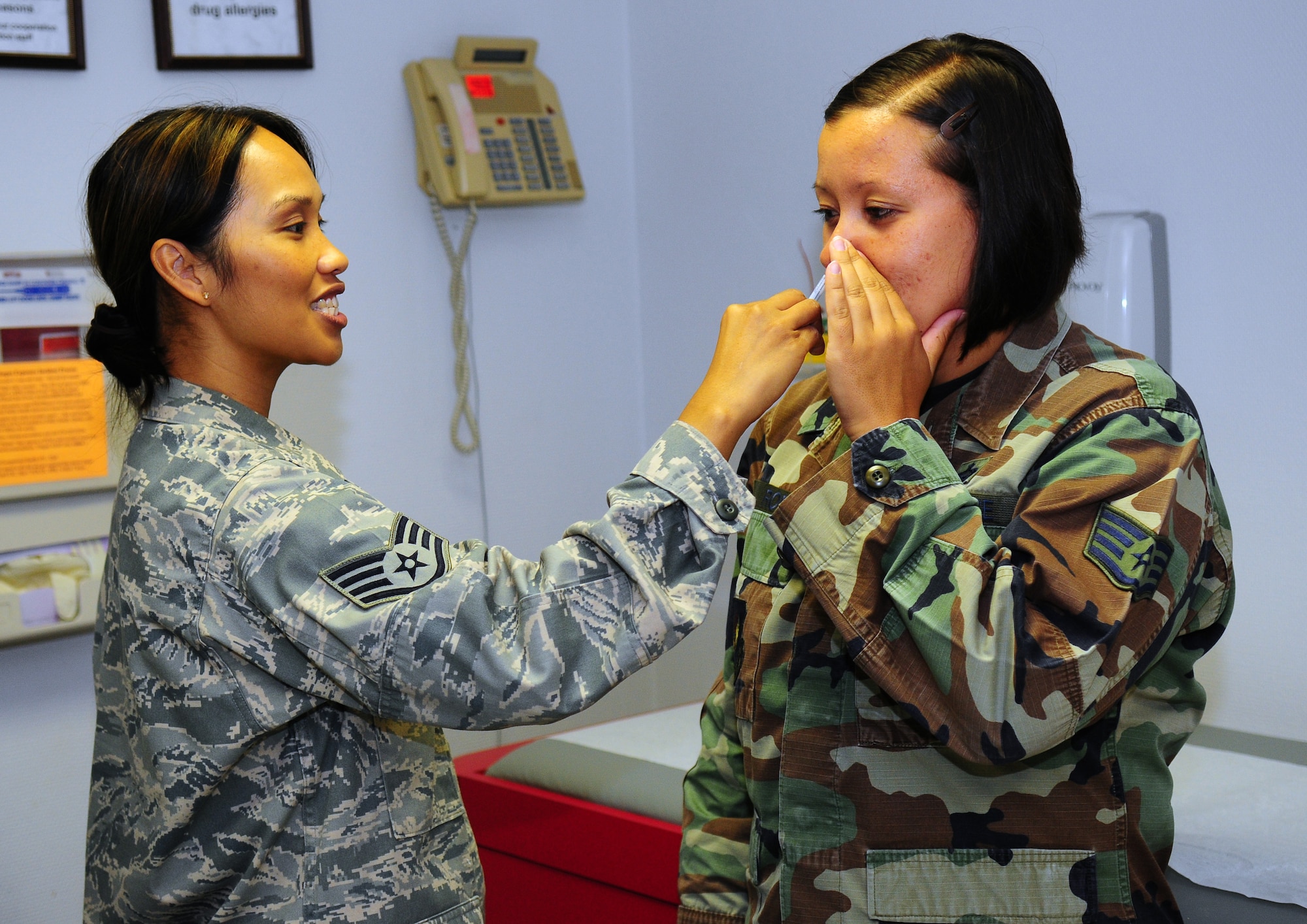 U.S. Air Force Staff Sgt. Glenda Castillo, a medical technician at the 86th Medical Group, administers the flu mist to Staff Sgt. Shauna Rode, a South Africa region intelligence analyst for the 17th Air Force, Ramstein Air Base, Germany, Aug. 26, 2009. "It is really busy around here with school about to start and the beginning of flu season coming up," Sergeant Castillo said. (U.S. Air Force photo by Staff Sgt. Jocelyn Rich)