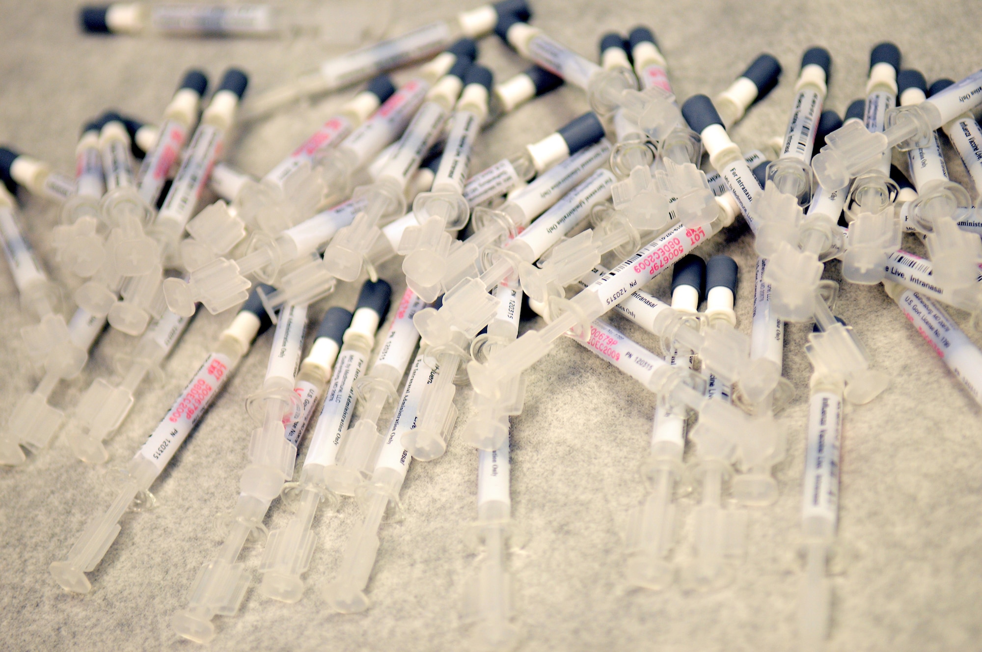 Flu mists lie on an examination table after immunizations technicians gathered them together to take around the clinic and administer them to clinic personnel, Ramstein Air Base, Germany, Aug. 26, 2009. (U.S. Air Force photo by Staff Sgt. Jocelyn Rich)