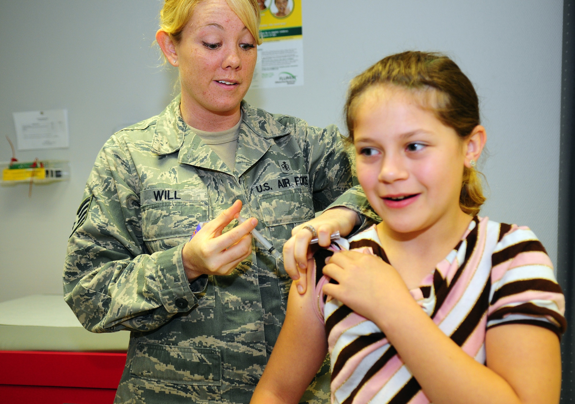 U.S. Air Force Staff Sgt. Amanda Will, a medical technician with the 86th Medical Group, gives an immunization shot to Alexandra Swift in preparation for the new school year, Ramstein Air Base, Germany, Aug. 26, 2009. (U.S. Air Force photo by Staff Sgt. Jocelyn Rich)