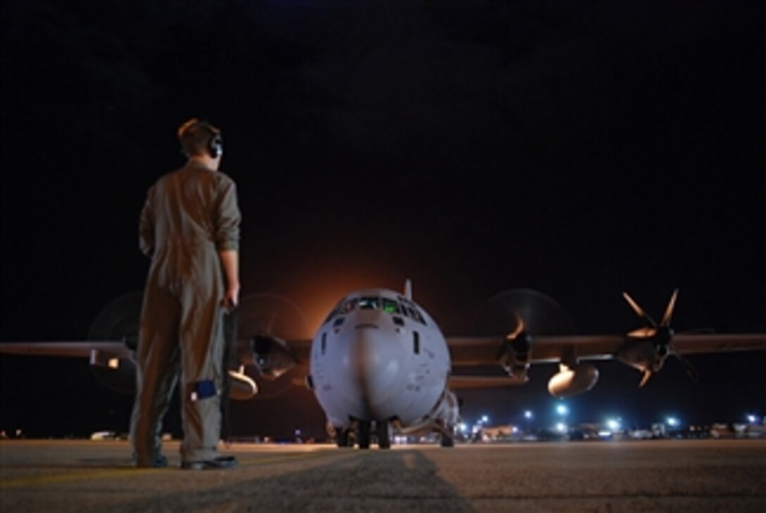 U.S. Air Force Tech. Sgt. Matt Couch, a loadmaster with the 53rd Weather Reconnaissance Squadron, communicates with the pilot as they prepare for a 10-hour mission into the remnant of Hurricane Felicia at Hickam Air Force Base, Hawaii, on Aug. 9, 2009.  Hurricane Felicia reached peak strength as a category 4 storm with sustained winds of more than 145 mph.  