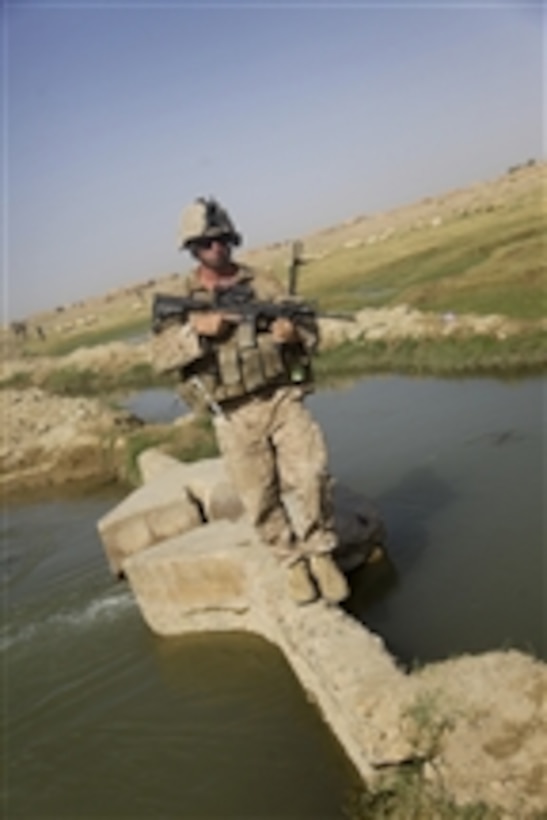 U.S. Marine Corps Sgt. Brian Kightlinger, with Bravo Company, 1st Battalion, 5th Marine Regiment, crosses a bridge over a canal during a security patrol through Nawa district, Helmand province, Afghanistan, on Aug. 22, 2009.  The 1st Battalion is deployed with Regimental Combat Team 3 to conduct counterinsurgency operations in partnership with Afghan security forces in southern Afghanistan.  
