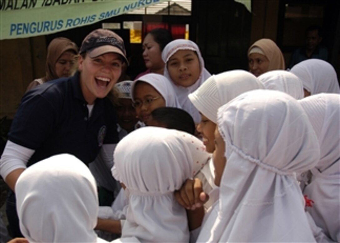 U.S. Navy Ensign Ashley Rushing, assigned to the USS Russell (DDG 59), greets a group of Indonesian girls during a community service project at Nural Falah Elementary School, as part of Cooperation Afloat Readiness and Training Indonesia 2009 in Jakarta, Indonesia, on Aug. 25, 2009.  Cooperation Afloat Readiness and Training is an annual exercise conducted between the U.S. and six Southeast Asian countries.  