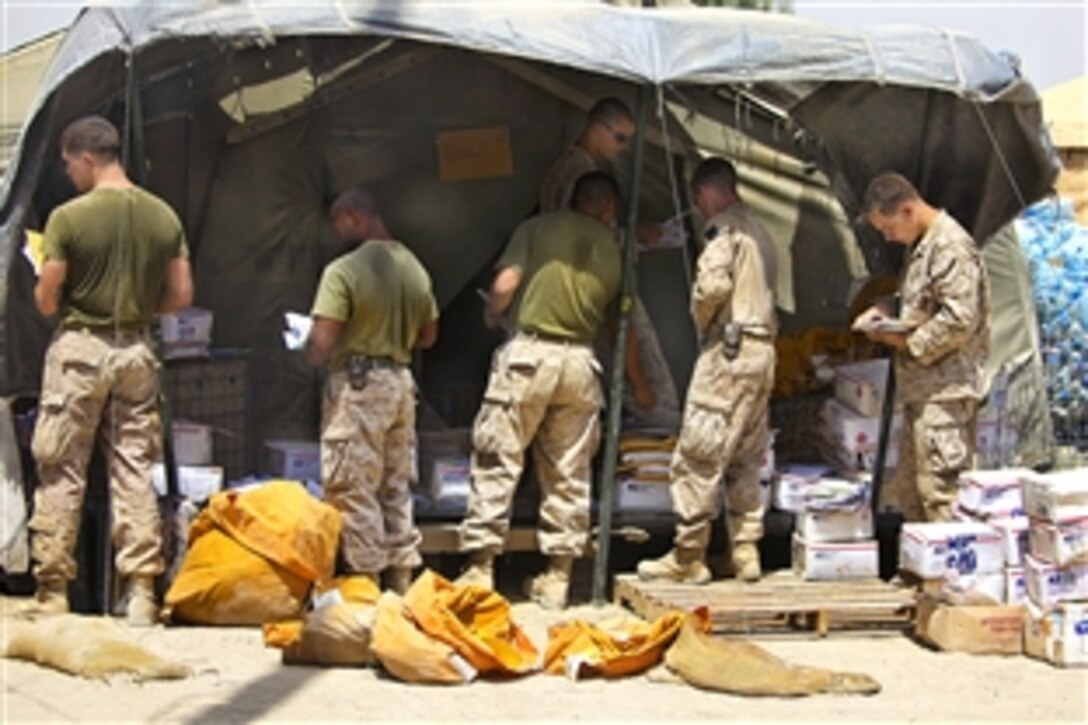 U.S. Marines sort mail on Patrol Base Jaker in Helmand province's Nawa district, Afghanistan, Aug. 23, 2009. The Marines, assigned to 1st Battalion, 5th Marine Regiment, are deployed with Regimental Combat Team 3.