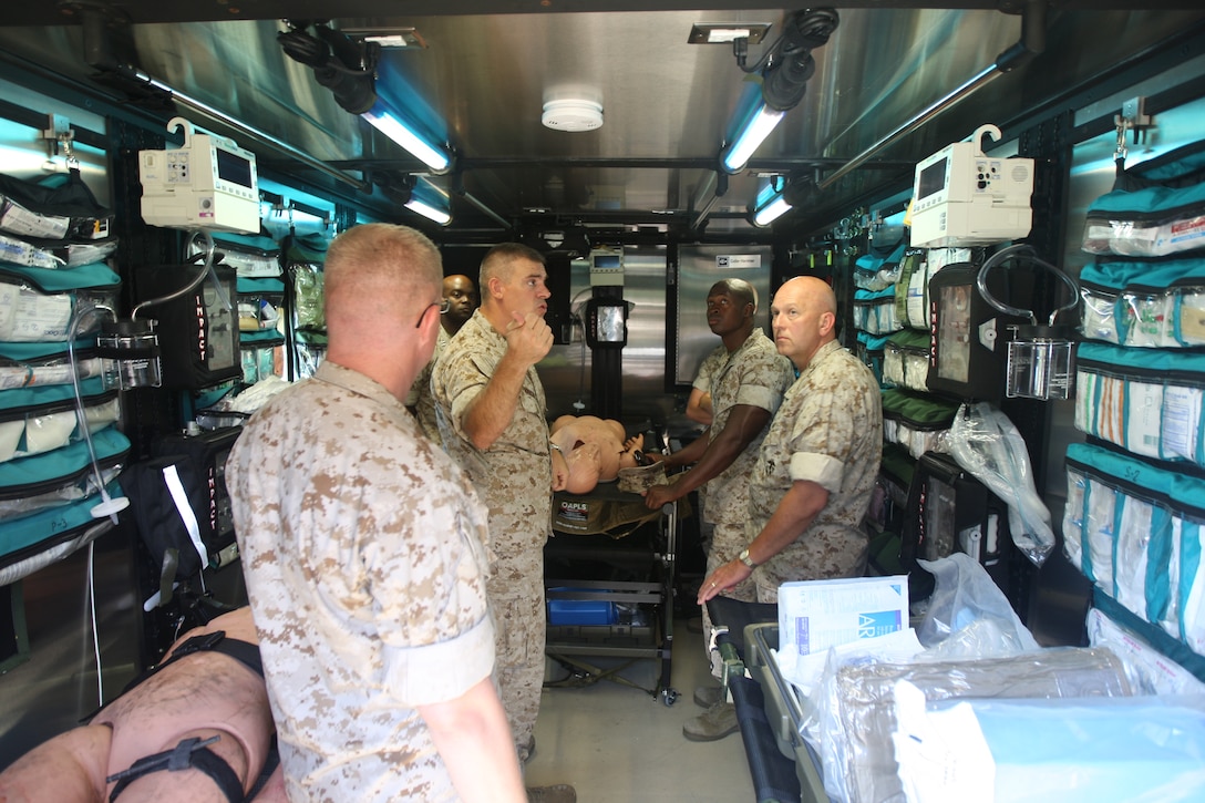 Cmdr James L. Hancock of medical services, Camp Lejeune Naval Hospital, explains the equipment inside the cargo shell of the Mobile Trauma Bay, August 27. Able to treat casualties at the point of contact, the MTB cuts evacuation and treatment times from hours down to minutes.