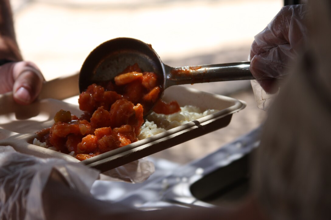 Marines with Marine Wing Support Squadron 374, serve fresh, hot food to training squadron Marines from the Field Food Service System at Camp Wilson Aug. 27.