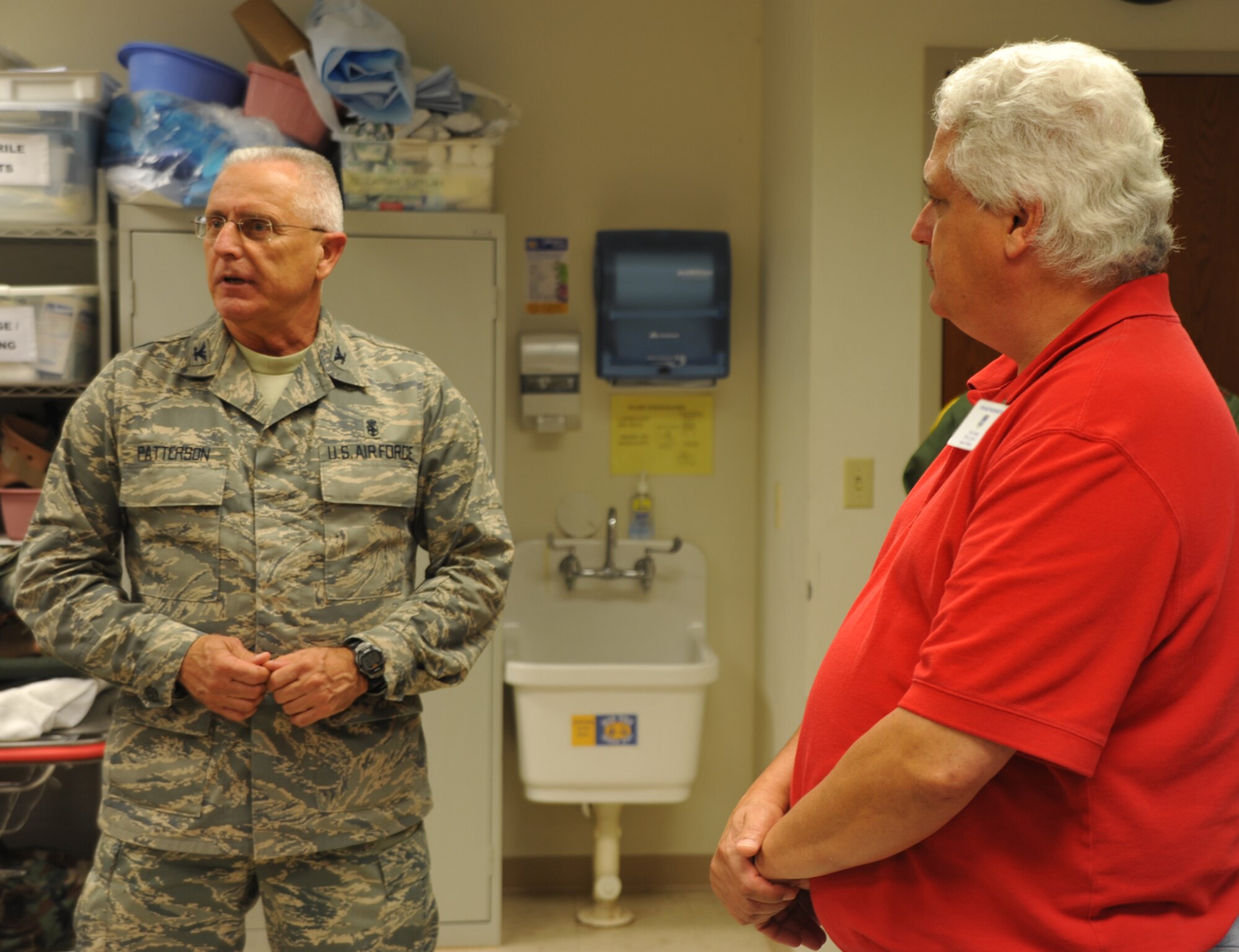 Col. James Patterson, commander of the 932nd Airlift Wing Medical Group, talks about his Air Force Reservists to a member of the community.   Col. Patterson is an accomplished speaker and writer.  (U.S. Air Force photo/Maj. Stan Paregien)