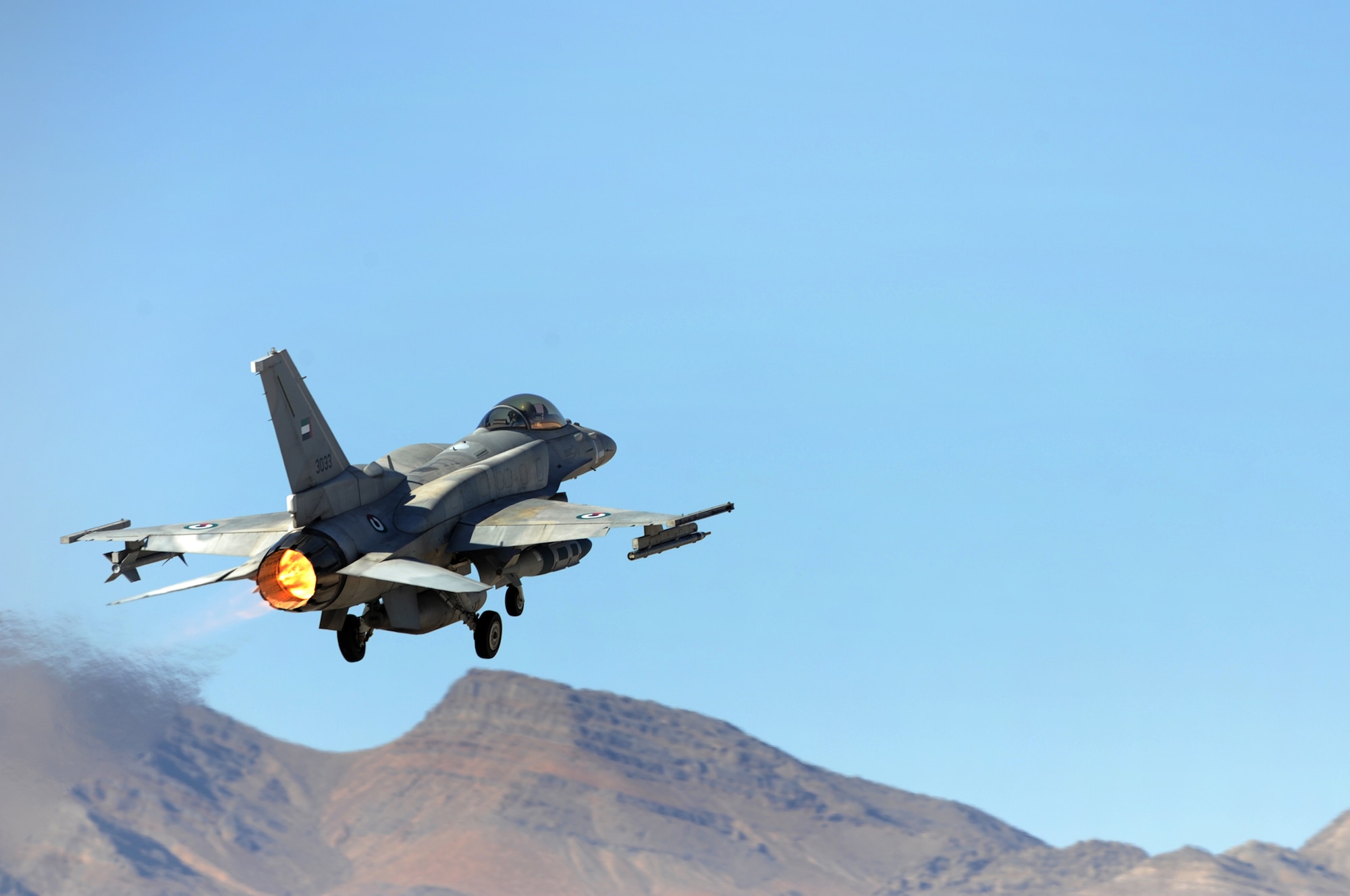 NELLIS AIR FORCE BASE Nev.-- An F-16E from Al Dhafra Air Base, United Arab Emirates, takes off for a training mission during Red Flag 09-5 Aug. 26.  This is the first time the nation has participated in Red Flag--a realistic air combat training exercise conducted over the 15,000-square-mile Nevada Test and Training Range north of Las Vegas. The two-week exercise is administered through the 414th Combat Training Squadron at Nellis Air Force Base and is just one in a series of advanced training programs offered by the U.S. Air Force Warfare Center. In addition to the United Arab Emirates, U.S. Air Force, Navy and Marines Corps units from Nevada, Massachusetts, Utah, Louisiana, California, Washington, Oklahoma, Florida and Kansas; as well as allied forces from Italy are participating in Red Flag 09-5.  The exercise ends Sept. 4. (U. S. Air Force photo by Tech. Sgt. Michael R. Holzworth/Released)

