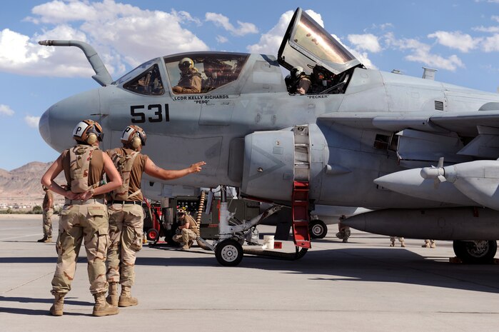 NELLIS AIR FORCE BASE, Nev.-- U.S. Navy Airman Fabian Lopez, a flight captain from Electronic Attack Squadron 133, Naval Air Station Whidbey Island, Wash., prepares to launch an EA-6B Prowler piloted by Lt. Cmdr. Kelly Richards, during a Red Flag 09-5 sortie Aug. 24. Red Flag is a realistic air combat training exercise conducted over the 15,000-square-mile Nevada Test and Training Range north of Las Vegas. The two-week exercise is administered through the 414th Combat Training Squadron at Nellis Air Force Base and is just one in a series of advanced training programs offered by the U.S. Air Force Warfare Center. U.S. Air Force, Navy and Marines Corps units from Nevada, Massachusetts, Utah, Louisiana, California, Washington, Oklahoma, Florida and Kansas are participating in Red Flag 09-5 along with allied forces from Italy and the United Arab Emirates. The exercise ends Sept. 4. (U.S. Air Force photo by Airman 1st Class Brett Clashman/Released)