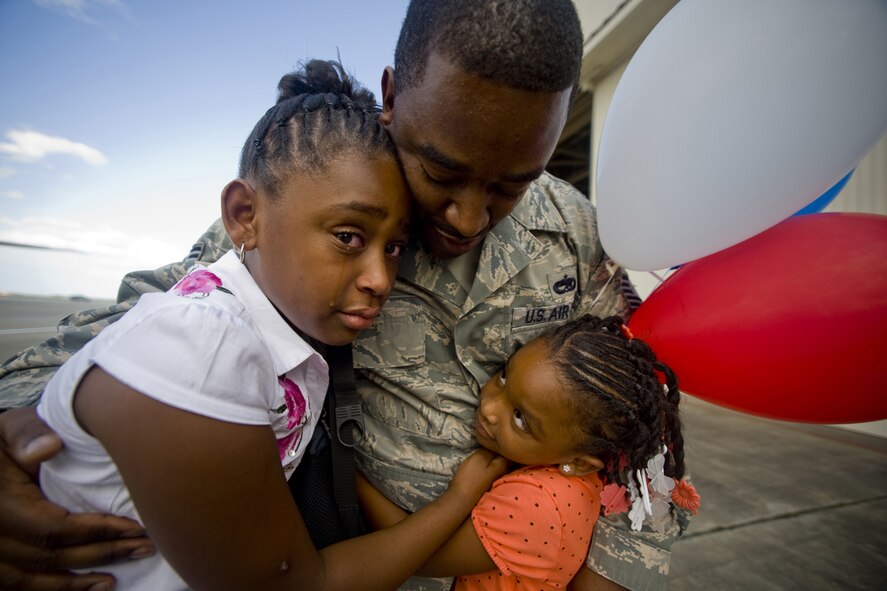 MISAWA AIR BASE, Japan -- Jaida and Jhamia White welcome their father, Tech. Sgt. Dexter White, 13th Aircraft Maintenance Unit, upon return from deployment Aug. 23. Sergeant White, along with members of his unit, supported the 13th Fighter Squadron during a deployment to Suwon Air Base, South Korea. (U.S. Air Force photo/Senior Airman Jamal D. Sutter)
