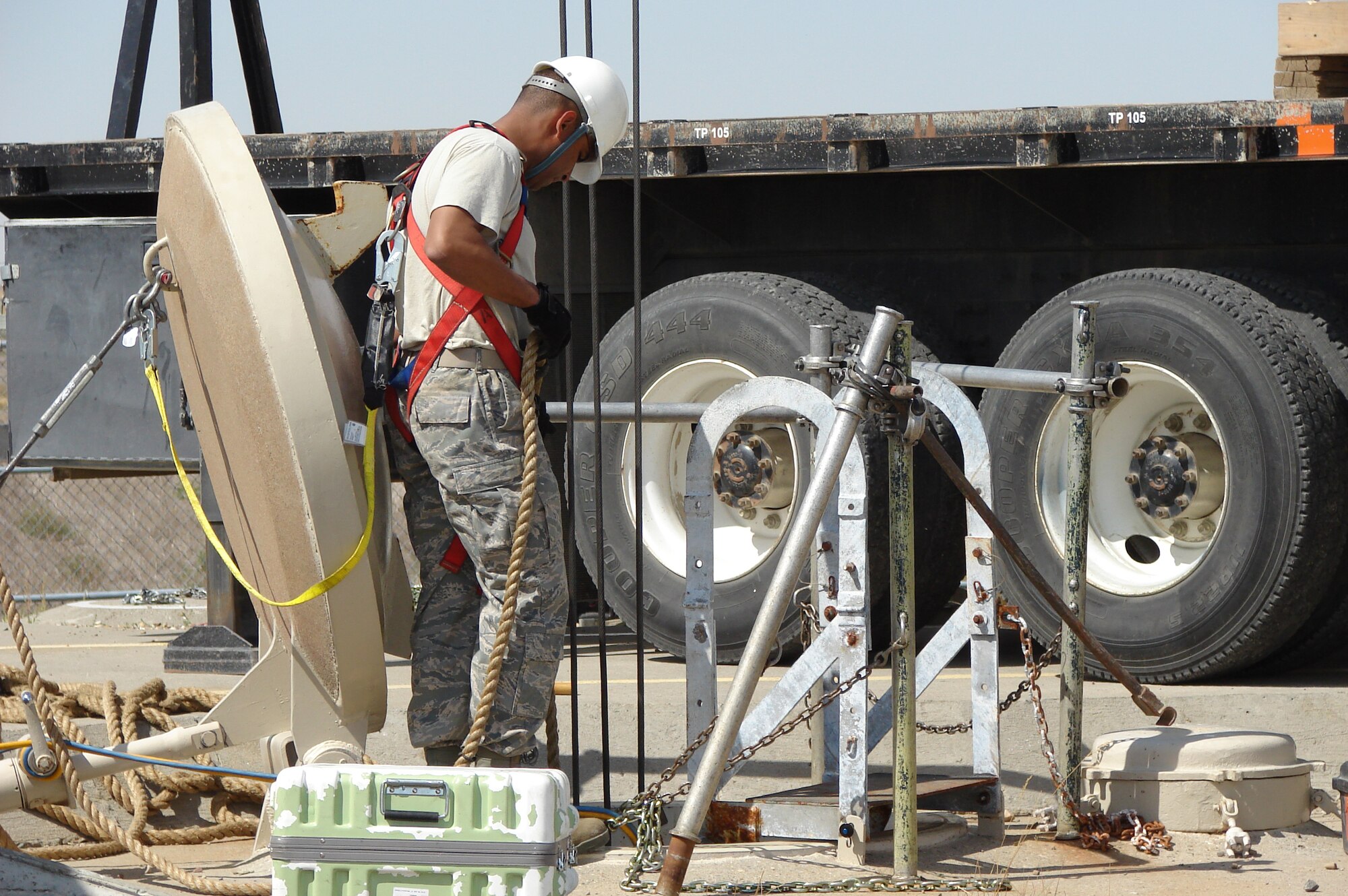 Tech. Sgt. Mario Ceballos-Martinez, 341st Missile Maintenance Squadron electro mechanical team critical tasks supervisor, mans the guide rope as a crane operator raises a piece of equipment out of the personnel access hatch Aug. 22. (U.S. Air Force photo/Capt. Franklin Adams)