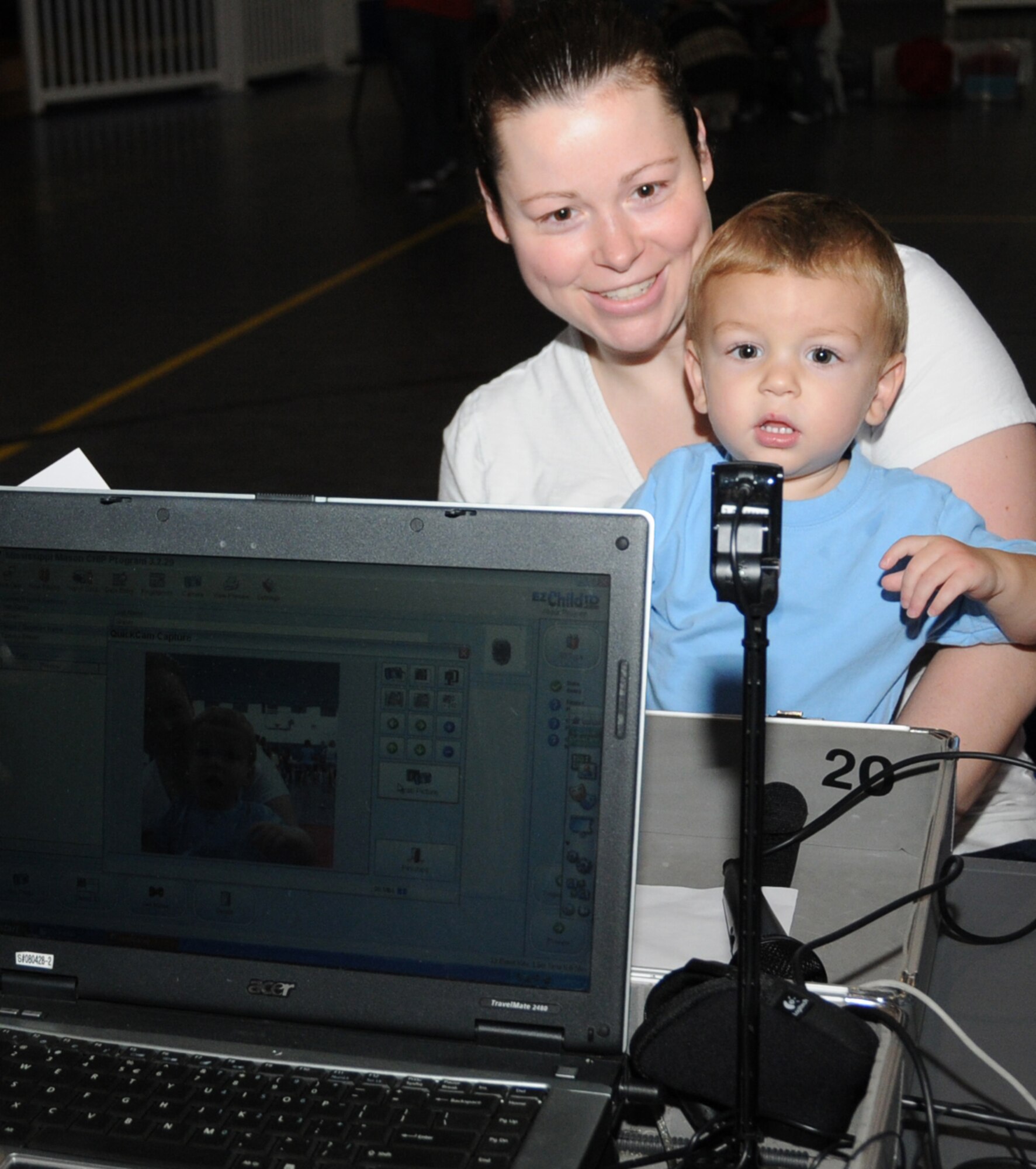 Senior Airman Tammy Sherer holds her 1-year-old son, William, as he’s photographed during Saturday’s Mississippi Child Identification Program at the youth center.  Airman Sherer is assigned to the 81st Medical Support Squadron.  The event processed 228 children.  (U.S. Air Force photo by Kemberly Groue)