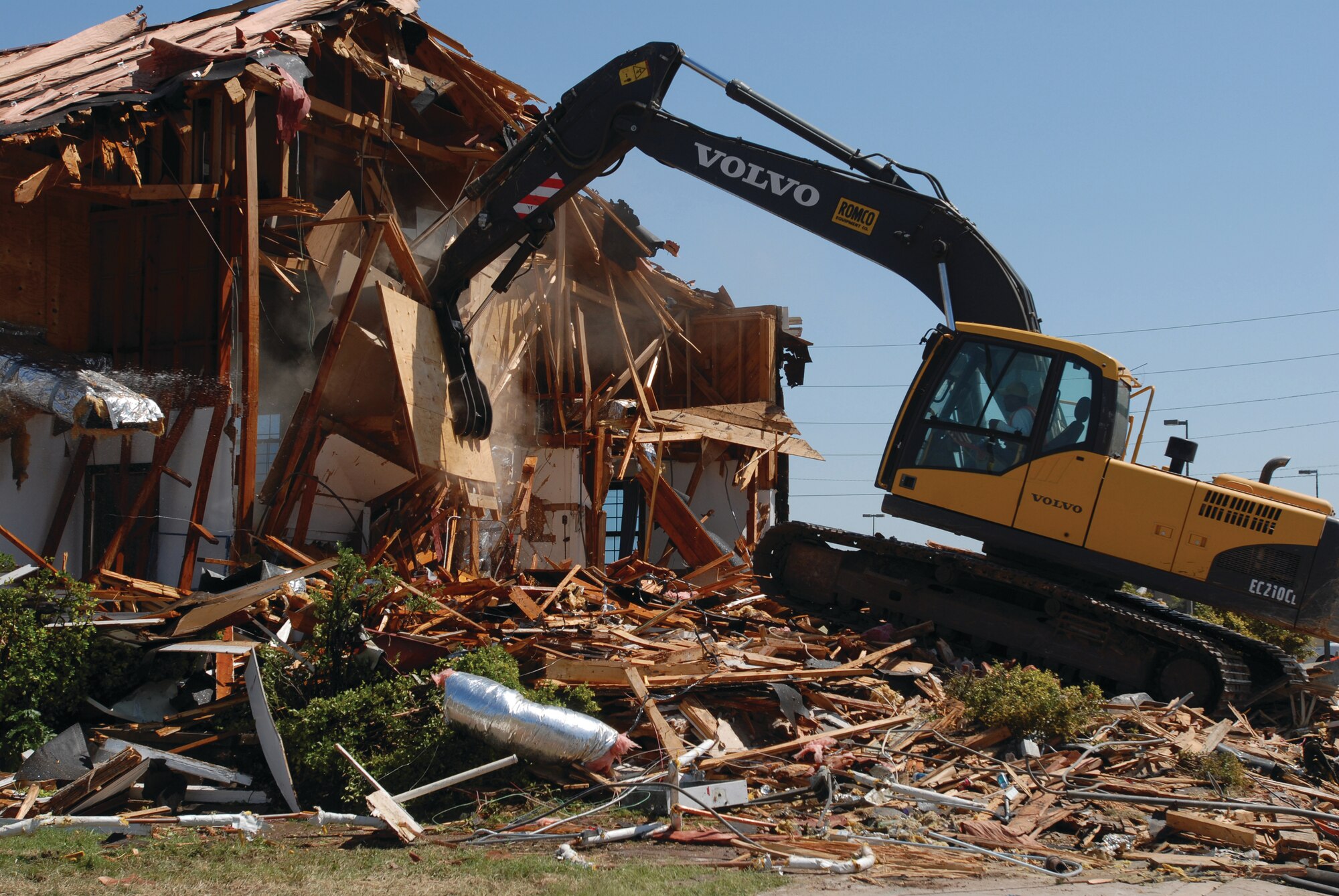 An excavator chips away at the chapel to complete the demolition. (U.S. Air Force photo by Airman Clayton Lenhardt)