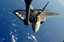 ANDERSEN AIR FORCE BASE, Guam -- An F-22 Raptor approaches the boom of a KC-135 Stratotanker to refuel over the Pacific Ocean Aug. 13. KC-135 Stratotankers, F-22 Raptors and B-52 Stratofortress bombers took part in the 2009 Inaugural Turkey Shoot, which allows air expeditionary units to plan and execute tactical missions with airframes that don't regularly train together. The F-22s are deployed from Elmendorf Air Force Base, Alaska, to Andersen AFB to support U.S. Pacific Command's Theater Security Package in the Asia-Pacific region. (U.S. Air Force photo/Senior Airman Christopher Bush)