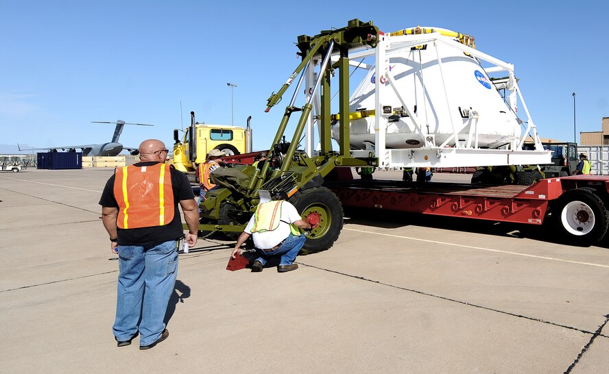 Crews work to place the Pad Abort One Crew Module on a tractor-trailer Aug. 20 at Holloman Air Force Base, N.M., before was transported to White Sands Missile Range, N.M. Aug. 21. The module is part of the Orion Program which will take the next generation of astronauts to space when the shuttle is replaced. (U.S. Air Force photo/Senior Airman Michael Means)
