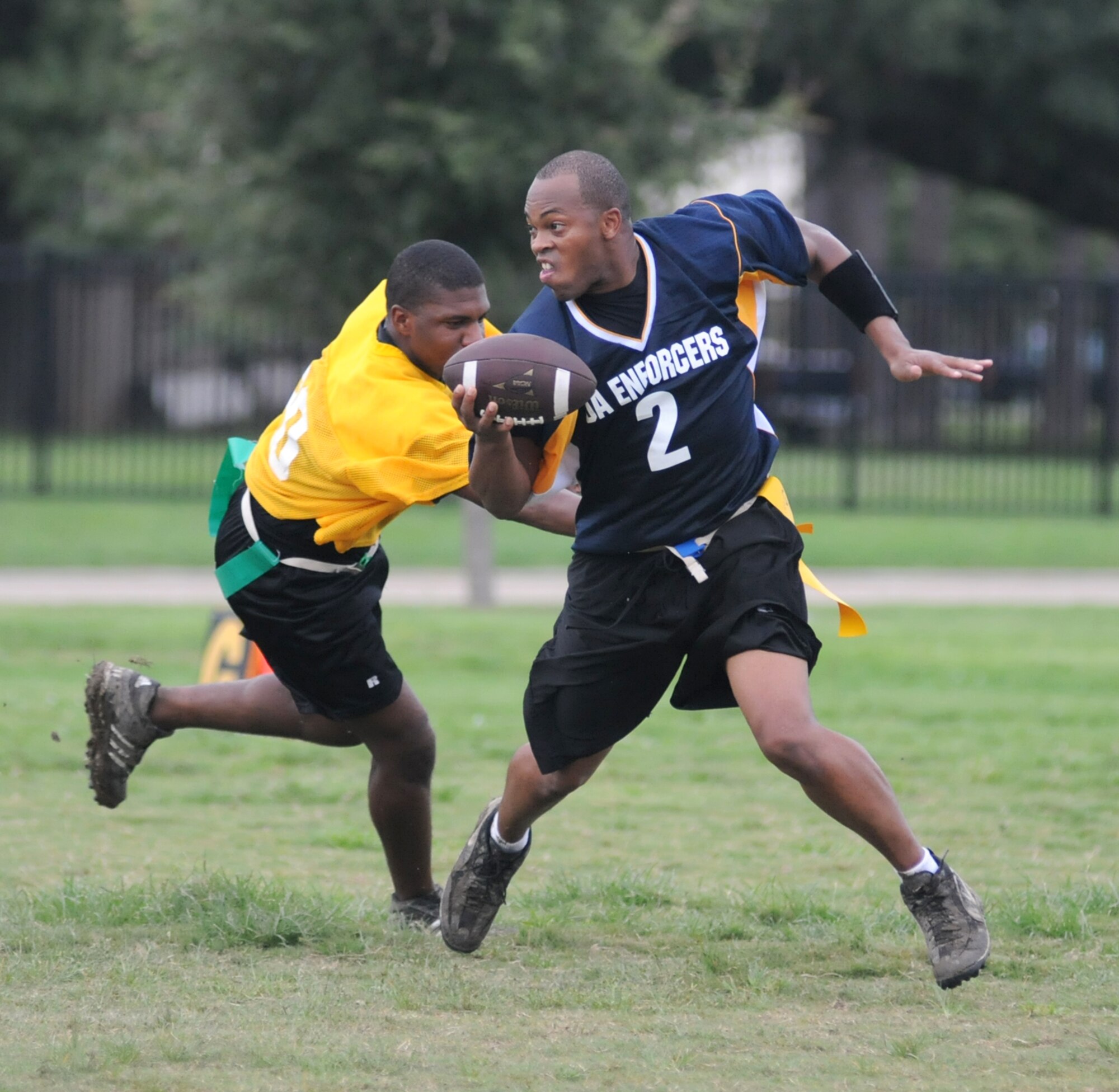 MARDET’s Marquis McQuire, left, reaches  for the flag of the 81st SFS quarterback, Edmon James, who decides to run the ball himself in the cops’ winning effort.  (U.S. Air Force photo by Kemberly Groue)