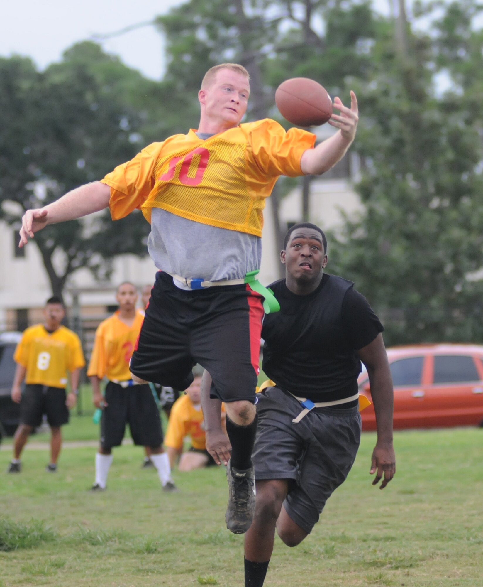 Keith Brooks leaps for a MARDET reception as Shannon Robinson, 81st SFS, moves in on defense.  (U.S. Air Force photo by Kemberly Groue)
