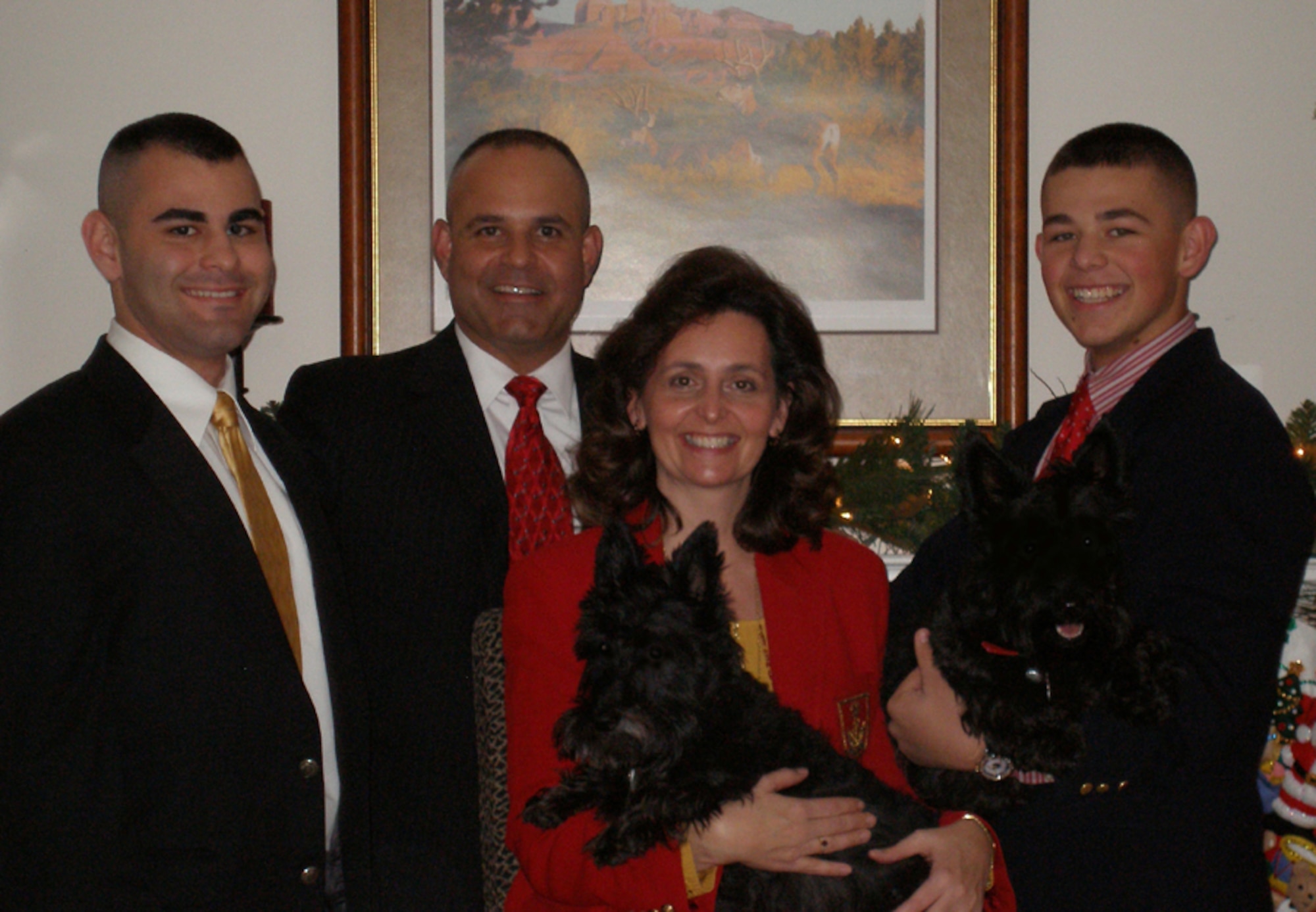 Col. Mohammed "Mo" Khan and his wife Lisa, pose for a family photo with sons Mohammed, left, and Simeon, right along with their family pets Nellie and Abby. (Courtesy photo)   