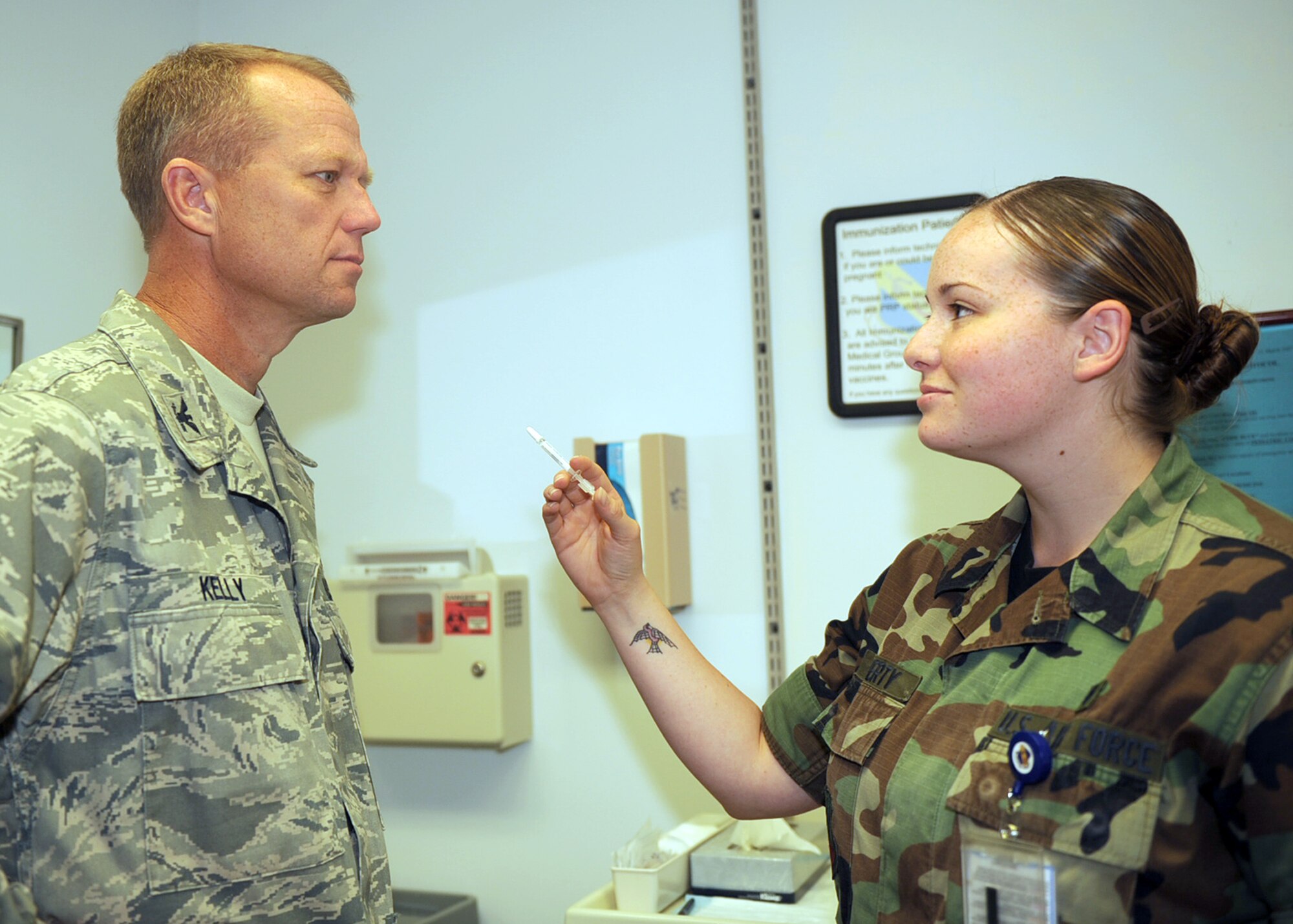 Airman 1st Class Courtney Doherty, 4th Medical Operations Squadron medical technician, prepares to give the FluMist vaccine to Col. Mark Kelly, 4th Fighter Wing commander, Aug. 25, 2009. Colonel Kelly helped the medical group kick off the campaign against influenza by being the first person to receive the mist. All squadrons will begin receiving the FluMist Sept. 3 until 100 percent of Airmen receive the vaccine. The flu season starts in October and stretches until May.  The vaccine is mandatory for all active duty, Department of Defense contractors and appropriated funds employees. Civilians will begin receiving the vaccine mid-October. (U.S. Air Force photo by Senior Airman Ciara Wymbs) 
 		
