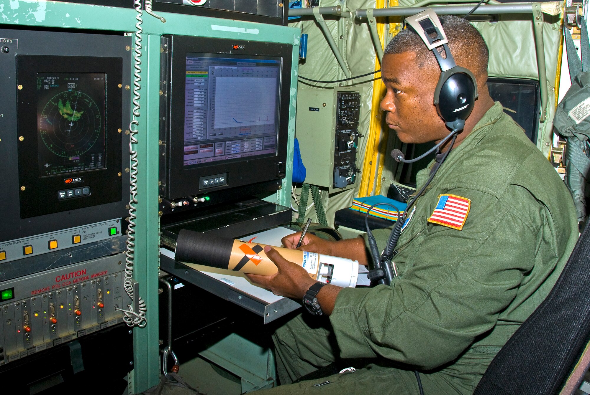 Air Force Reservist Tech. Sgt. Troy Bickham loads a dropsonde in the launch chute just before the WC-130J penetrates Hurricane Bill Aug. 22.  Sergeant Bickham is a weather reconnaissance loadmaster assigned to the 53rd Weather Reconnaissance Squadron "Hurricane Hunters," which is part of the 403rd Wing located at Keesler Air Force Base, Miss.  This particular mission was the last flight through Hurricane Bill, which was a Category 1 at the time of the flight.