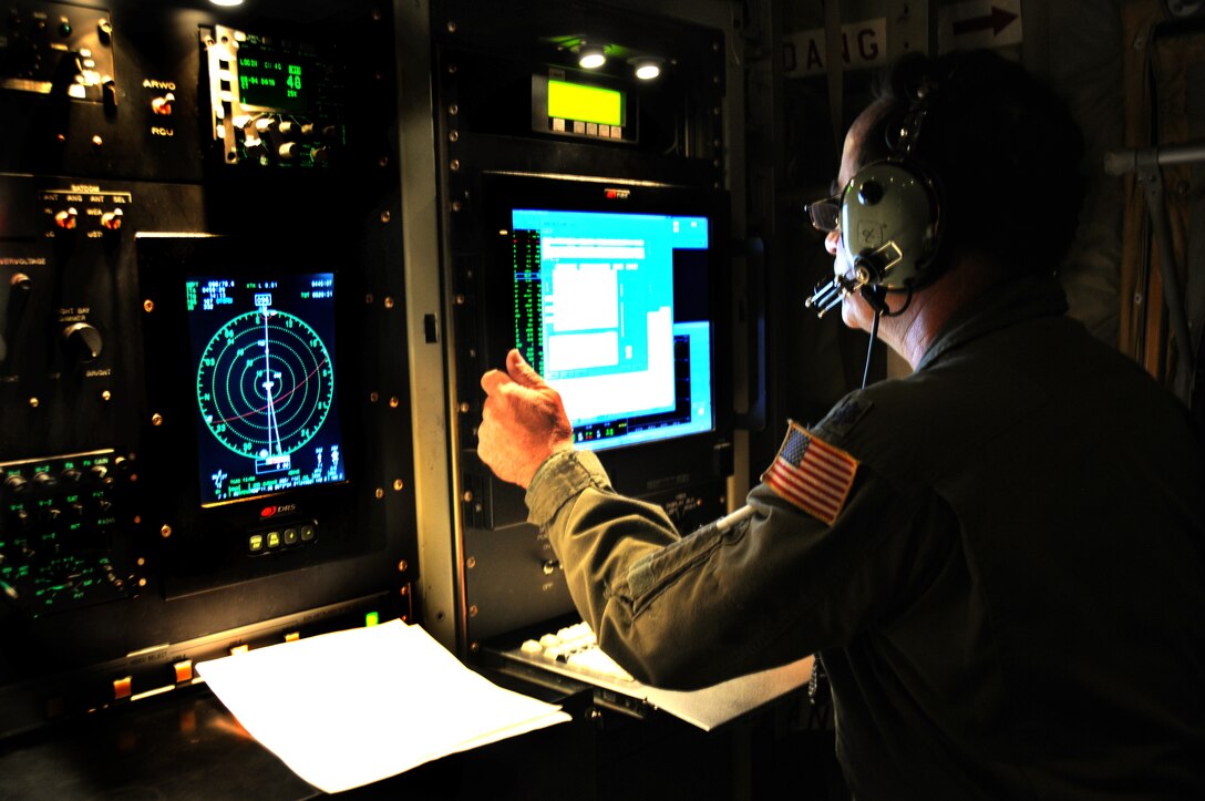 Air Force Reservist Lt. Col. Rich Harter, Aerial Reconnaissance Weather Officer with the 53rd Weather Reconnaissance Squadron located at Keesler Air Force Base, Miss., continuously monitors weather data on a WC-130J during a flight through Hurricane Bill Aug. 22.  The 53rd WRS "Hurricane Hunters" provide surveillance of tropical storms and hurricanes in the Atlantic Ocean, the Caribbean Sea, the Gulf of Mexico and the central Pacific Ocean for the National Hurricane Center in Miami.  (U.S. Air Force Photo by Staff Sgt. Tanya King)