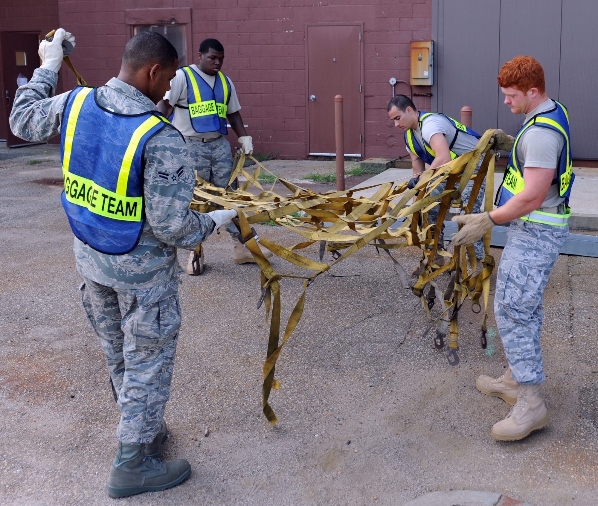 LANGLEY AIR FORCE BASE, Va. -- Members of the Operational Readiness Exercise baggage team prepare a cargo net for a pallet during a Phase I Operational Readiness Exercise here Aug. 27. The ORE is designed to establish Langley's expeditionary readiness and efficiency in deploying Airmen.  More than 2,500 Airmen will be involved in the exercise, which will measure the 1 FW's capabilities on graded, step-by-step guidelines which involve preparing aircraft, cargo and Airmen to deploy seamlessly within an established period of time. (U.S. Air Force photo/Airman1st Class Jonathan Koob)