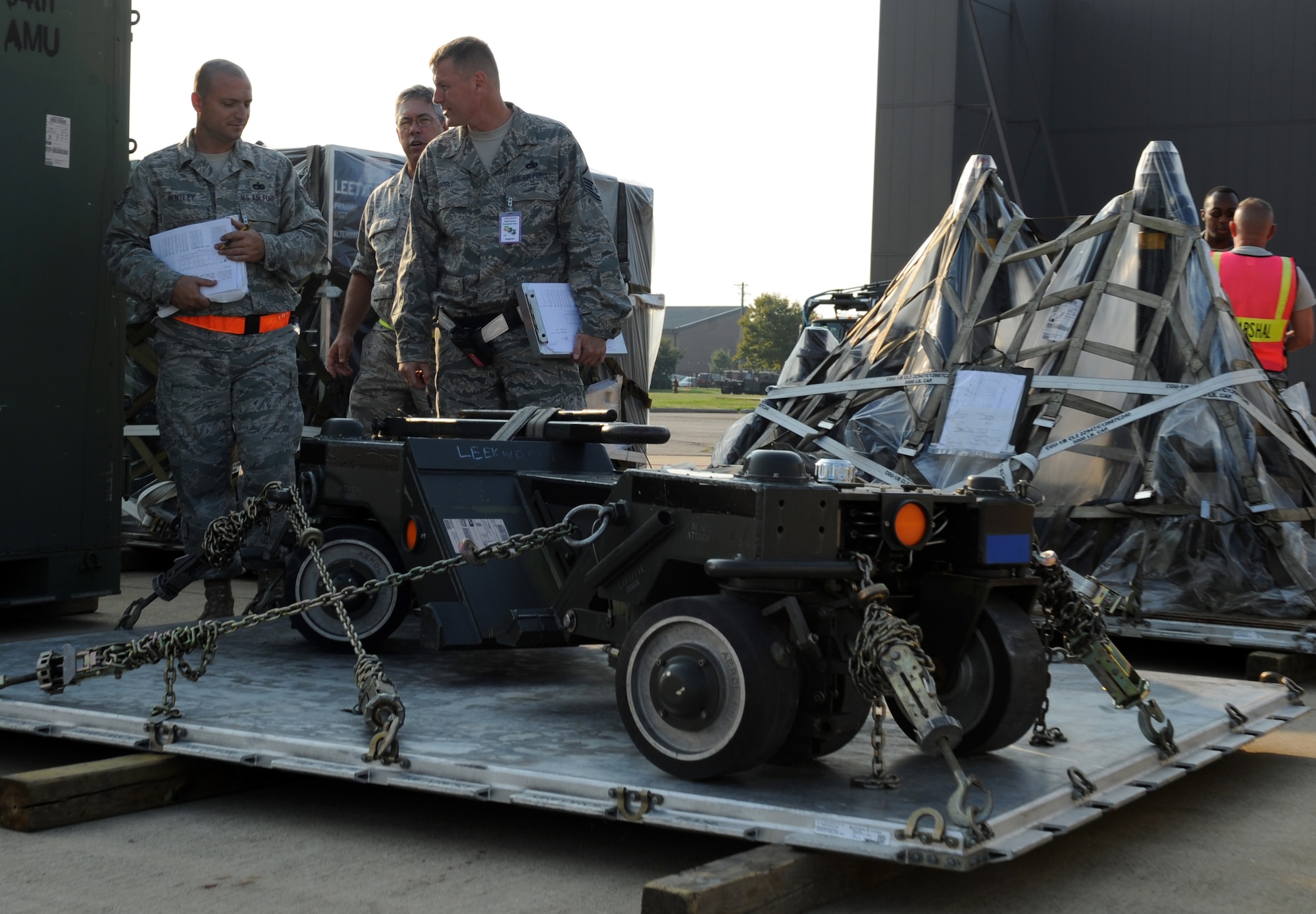 LANGLEY AIR FORCE BASE, Va. -- Tech. Sgt. Durell Bentley, 1st Communications Squadron client systems team non-commissioned officer in charge, and Master Sgt. Scott Brogli, 1st Logistics Readiness Squadron management and systems flight, inspect cargo for the Operational Readiness Exercise here Aug. 27. The ORE is designed to establish Langley's expeditionary readiness and efficiency in deploying Airmen. More than 2,500 Airmen will be involved in the exercise, which will measure the 1 FW's capabilities on graded, step-by-step guidelines which involve preparing aircraft, cargo and Airmen to deploy seamlessly within an established period of time. (U.S. Air Force photo/Airman1st Class Jonathan Koob)