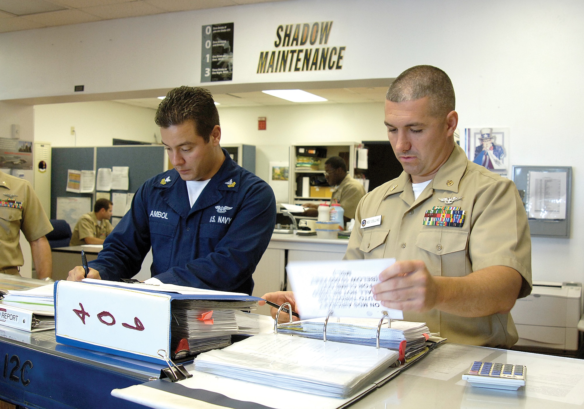 Chief Petty Officer Phil Stevens, right, and Petty Officer 1st Class Robert Ambol handle maintenance control for VQ-4.  Everything that happens with an aircraft during maintenance in the squadron funnels through their area to keep things working smoothly. (Air Force photo by Margo Wright)