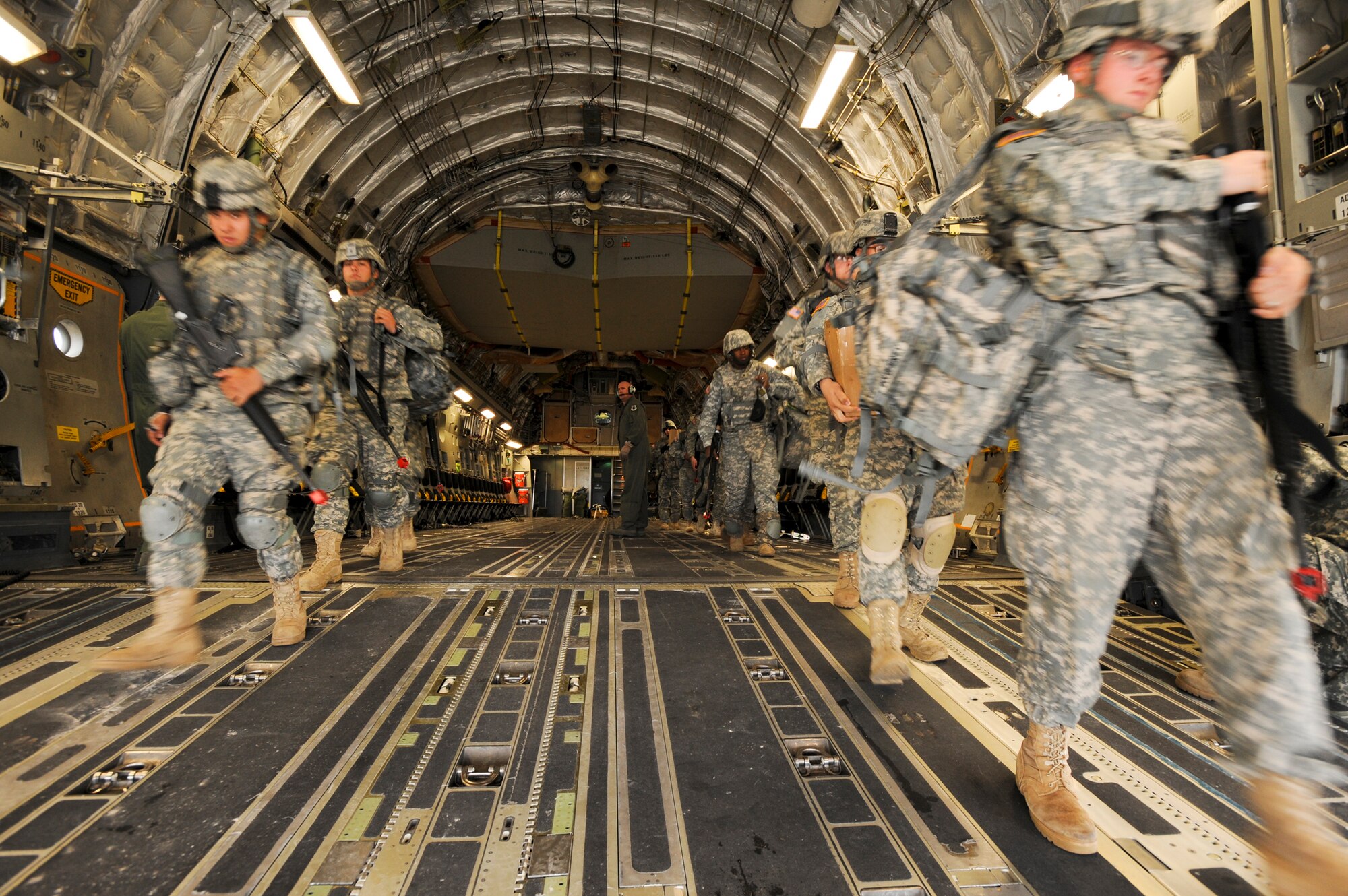 DONNELLY LANDING ZONE, Alaska -- Members from the 17th Combat Service Support Battalion out of Fort Richardson, walk out of the back of a C-17 Globemaster III after arriving at their location for Arctic Response, August 24. Arctic Response was a joint operation and total force integration exercise where Air Force active-duty and National Guard members aided the Army in deploying to the exercise site. (U.S. Air Force photo/ Staff Sgt. Joshua Garcia)