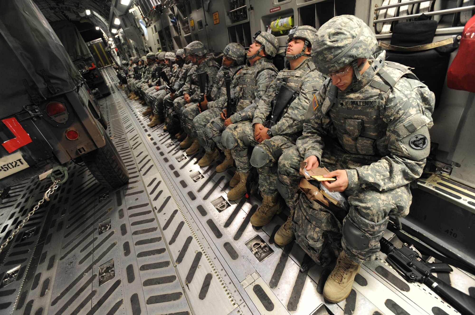 OVER ALASKA RANGE -- Members from the 17th Combat Service Support Battalion out of Fort Richardson, keep themselves busy during flight while on a C-17 Globemaster III, August 24, heading toward the designated location for Arctic Response.  Arctic Response was a joint operation and total force integration exercise where Air Force active-duty and National Guard members aided the Army in deploying to the exercise site. (U.S. Air Force photo/ Staff Sgt. Joshua Garcia)


