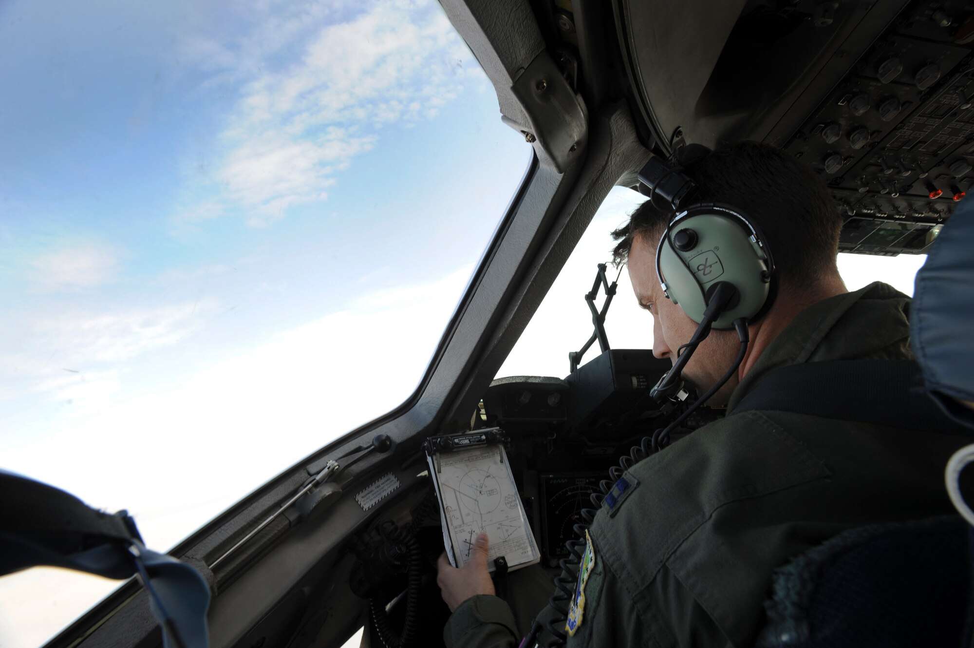 OVER ALASKA RANGE -- Capt. Nathan Drewry, 517th Airlift Squadron pilot, goes over his coordinates during flight, August 24, for Arctic Response.  Arctic Response was a joint operation and total force integration exercise where Air Force active-duty and National Guard members aided the Army in deploying to the exercise site. (U.S. Air Force photo/ Staff Sgt. Joshua Garcia)

