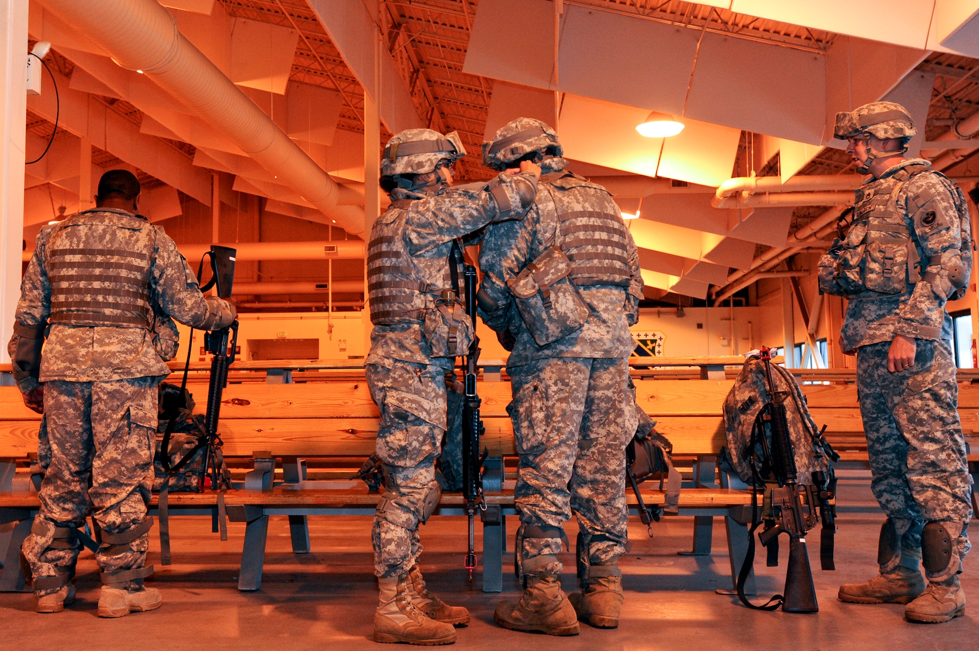 ELMENDORF AIR FORCE BASE, Alaska -- Members from the U.S. Army 17th Combat Service Support Battalion out of Fort Richardson check each other's gear prior to take off for Arctic Response here, August 24. Arctic Response was a joint operation and total force integration exercise where Air Force active-duty and National Guard members aided the Army in deploying to the exercise site. (U.S. Air Force photo/ Staff Sgt. Joshua Garcia)

