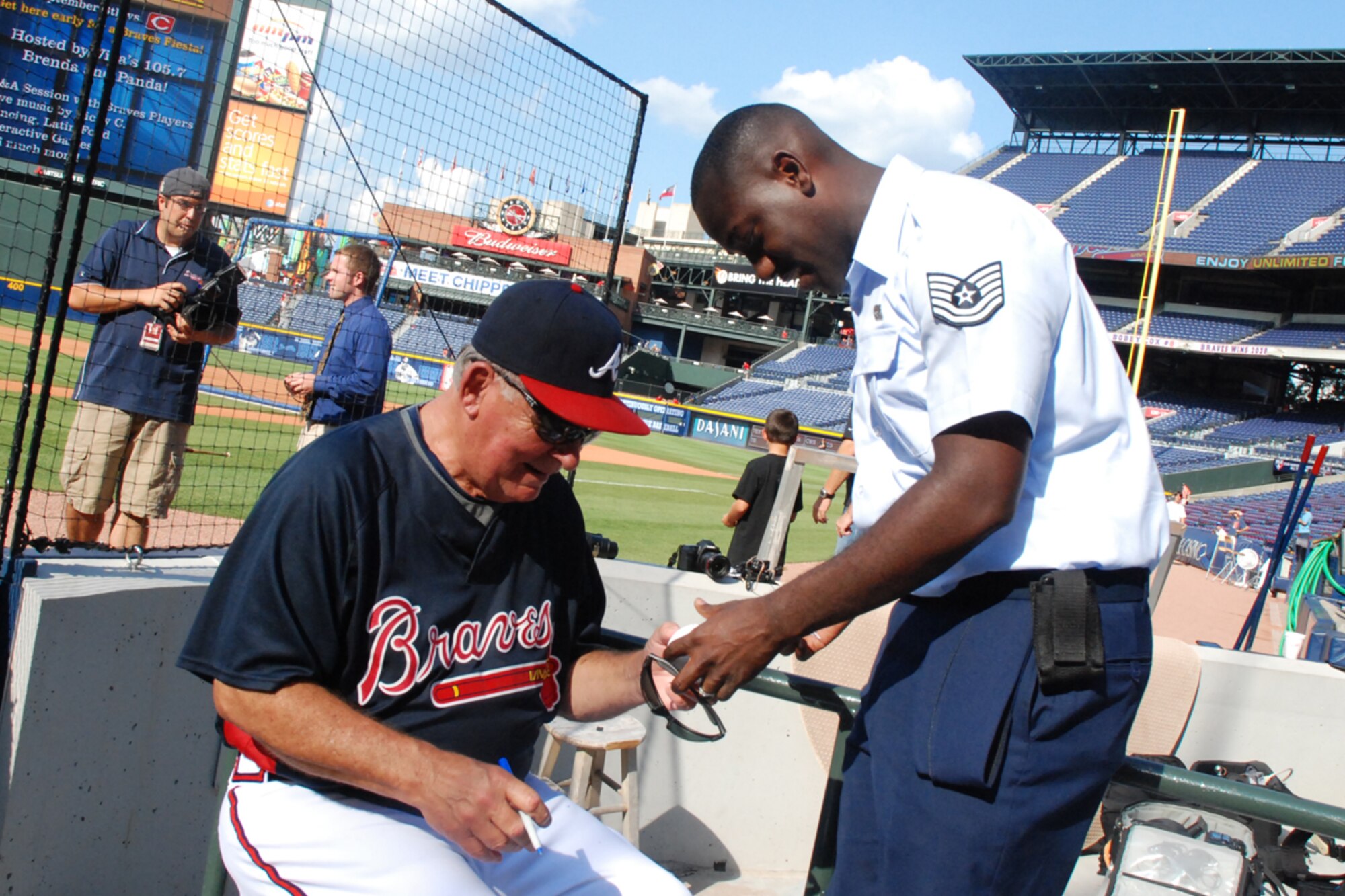 Tech. Sgt. Clarence Greene, aerial transportation technician, 80th Aerial Port Squadron, gets a Major League Baseball autographed by Atlanta Braves General Manager, Bobby Cox Aug. 26. (U.S. Air Force photo/Tech. Sgt. James Branch)