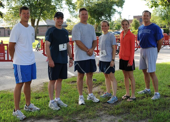 Col. John Wood, second from left, Col. Don Shaffer, right, and Chief Master Sgt. Mike Ivey, left center, are joined by their teammates during the 7th annual triathlon held here Aug. 22. Their teammates included members from the 16th Airlift Squadron and 437th Airlift Wing staff. Colonel Wood is the 437 AW commander, Colonel Shaffer is the 437 AW vice commander and Chief Ivey is the 437 AW command chief. (U.S. Air Force photo/Senior Airman Katie Gieratz)
