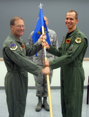 Lt. Col. Craig Jones (right), 706th Fighter Squadron commander, receives the guidon from Col. Herman Brunke, 926th Group commander, during a change of command ceremony at Nellis Air Force Base, Nev., on Aug. 21. As commander, Colonel Jones oversees Air Force Reserve Command members assigned to the United States Air Force Warfare Center, supporting missions in its 57th Wing, 53rd Wing and 505th Command and Control Wing. Additionally, he manages pilots flying A-10, F-15C, F-15E, F-16 and F-22 aircraft. (U.S. Air Force Reserve photo/Capt. Jessica Martin)