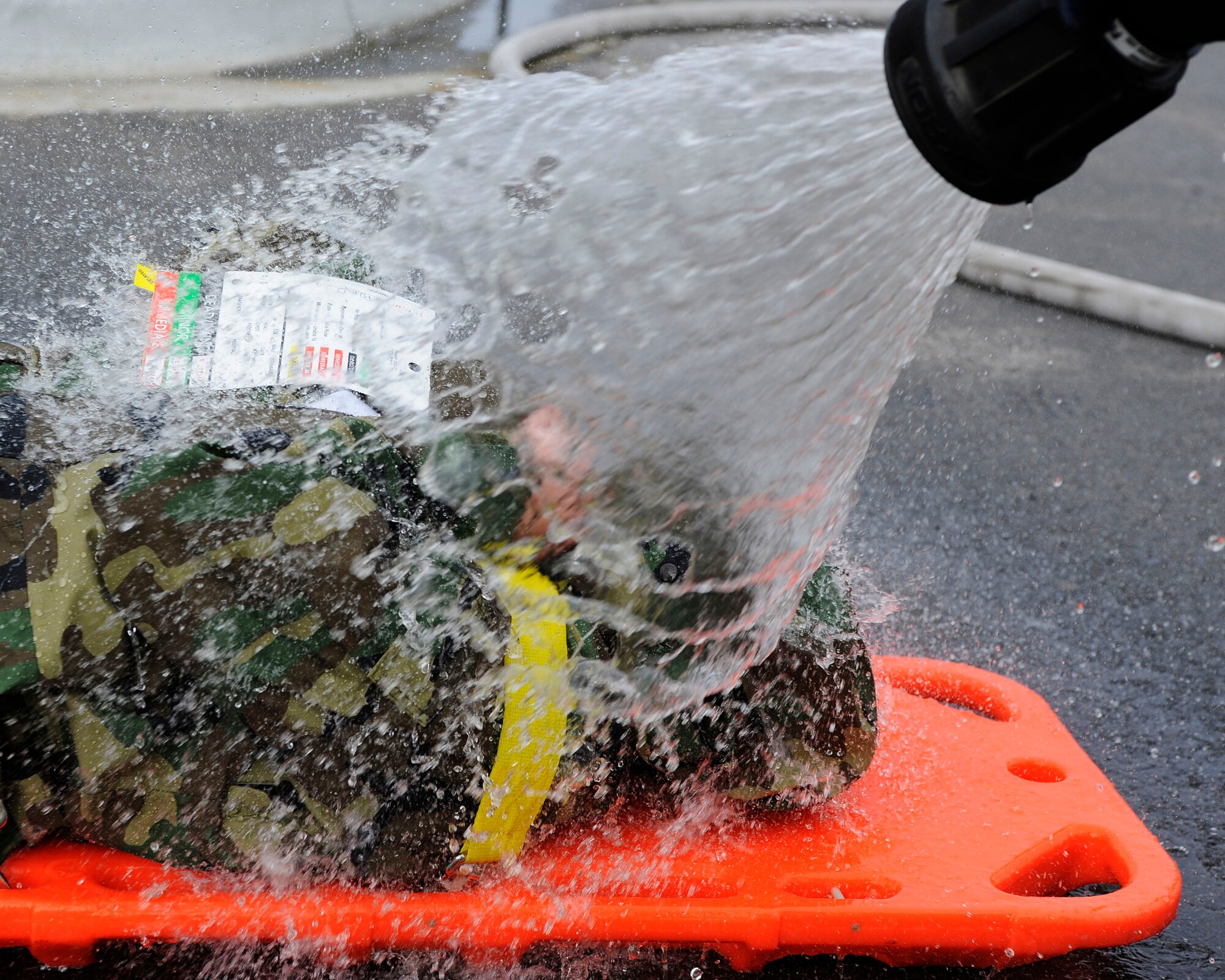 A mock victim is decontaminated during the emergency management exercise Aug. 26, 2009, Eielson Air Force Base, Alaska. Emergency responders were required to wear personal protective equipment when in the exercises immediate area to fully simulate a real world chemical incident. (U.S. Air Force photo/Airman 1st Class Willard E. Grande II)